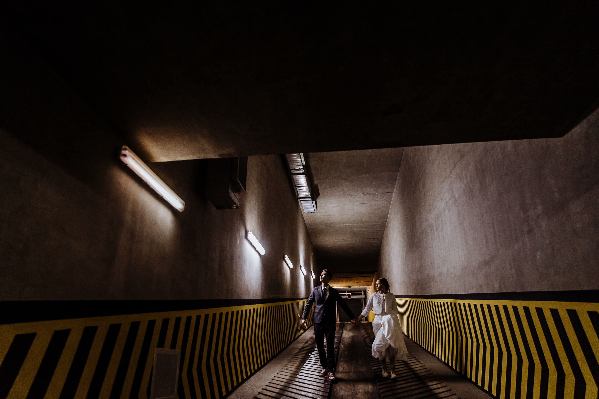 Long shot of couple walking in car park, by Tanya Bogdan, Bude wedding photography.  