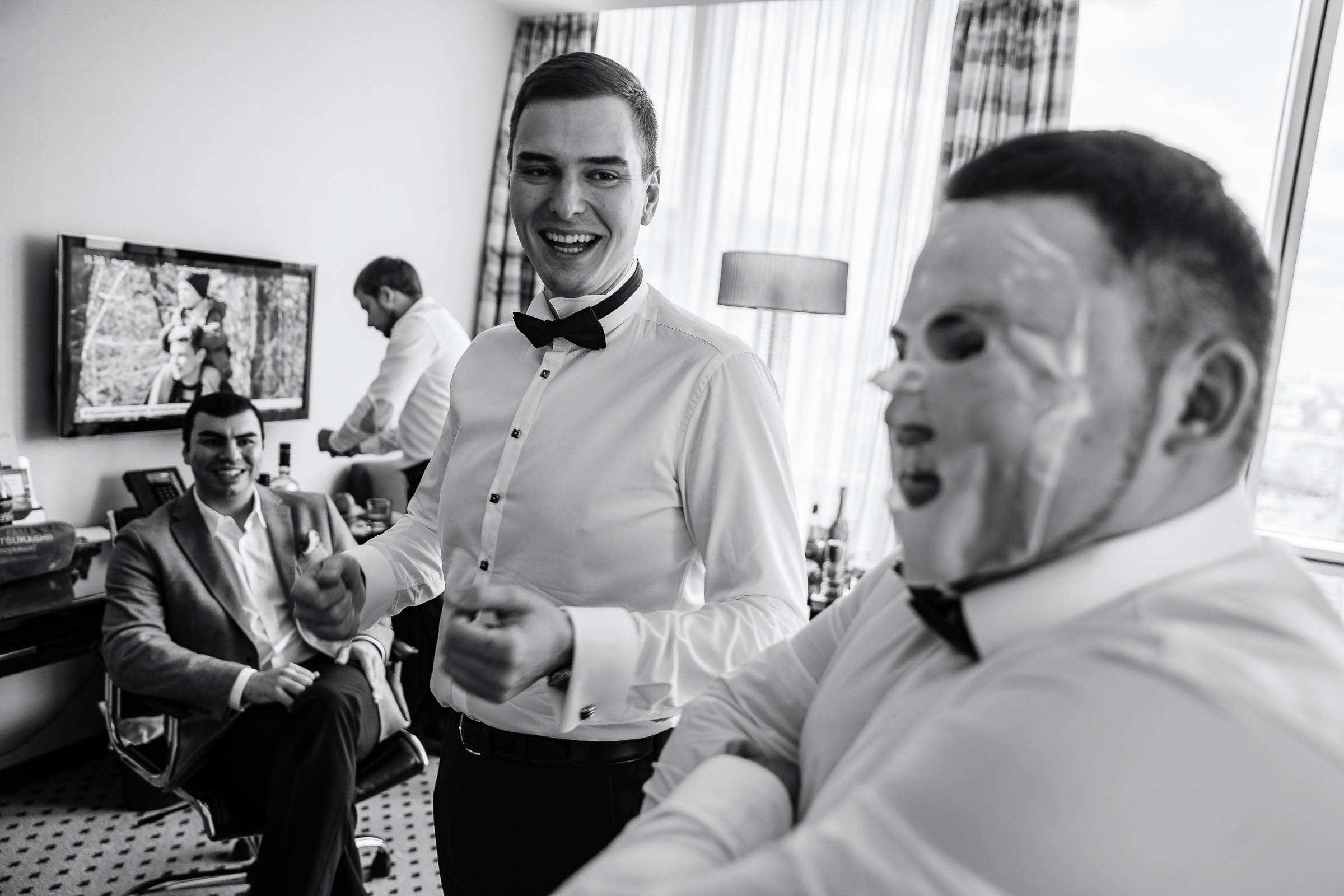 Groom’s candid prep in venue, by Tanya Bodgan, Plymouth wedding photography.  