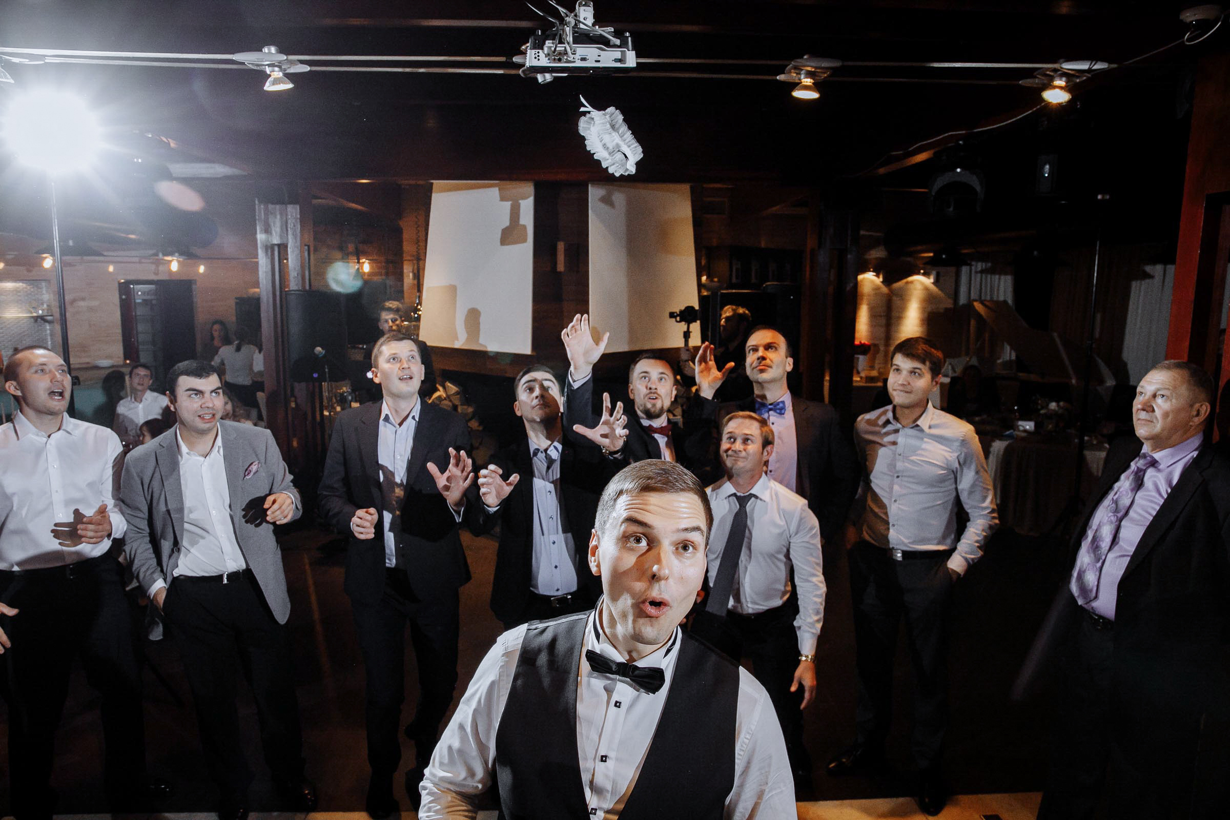 The garter toss by Tanya Bodgan, Cornwall wedding photographer.  