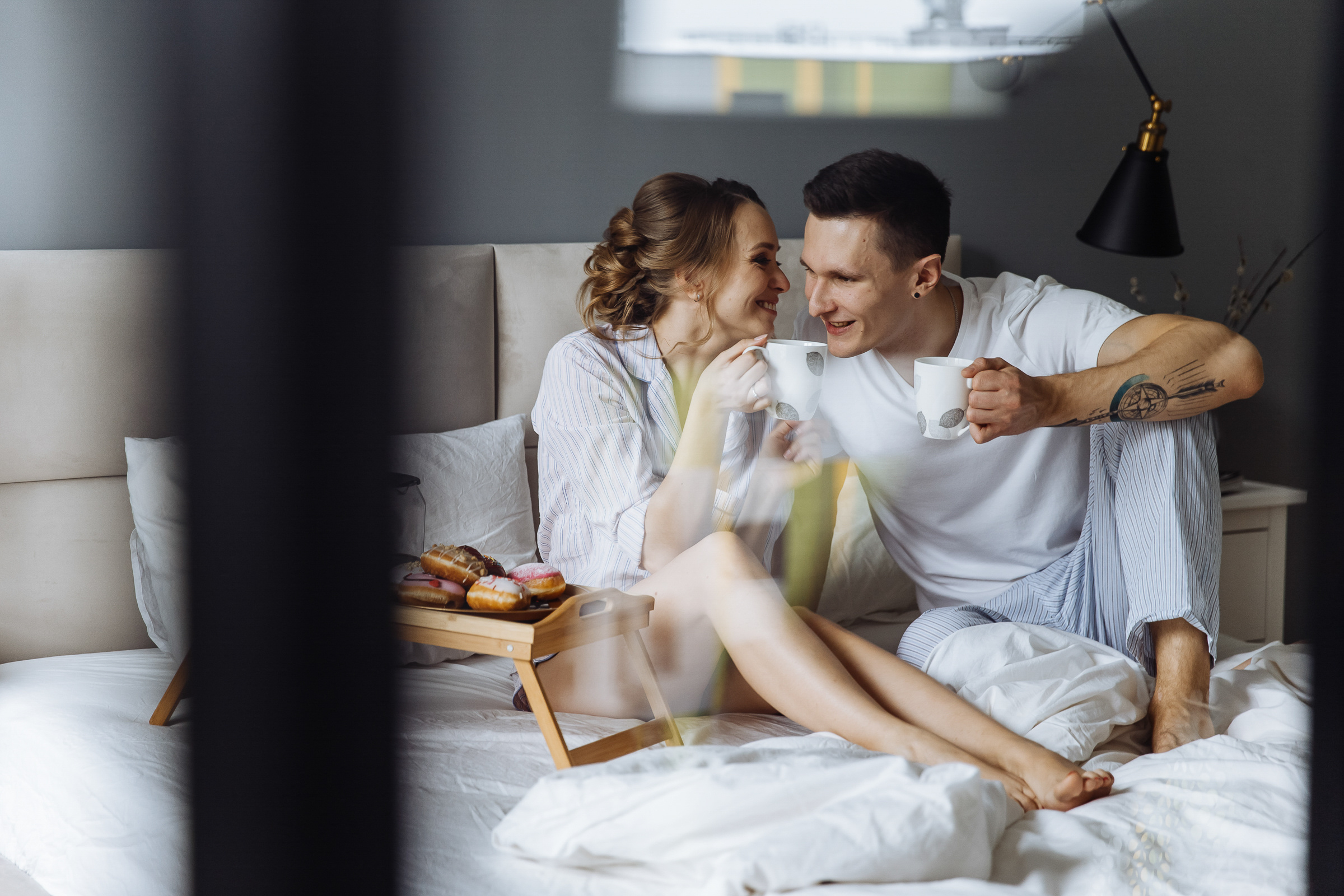 Couple’s morning portrait through window, by Tanya Bogdan, St Ives wedding photography.  