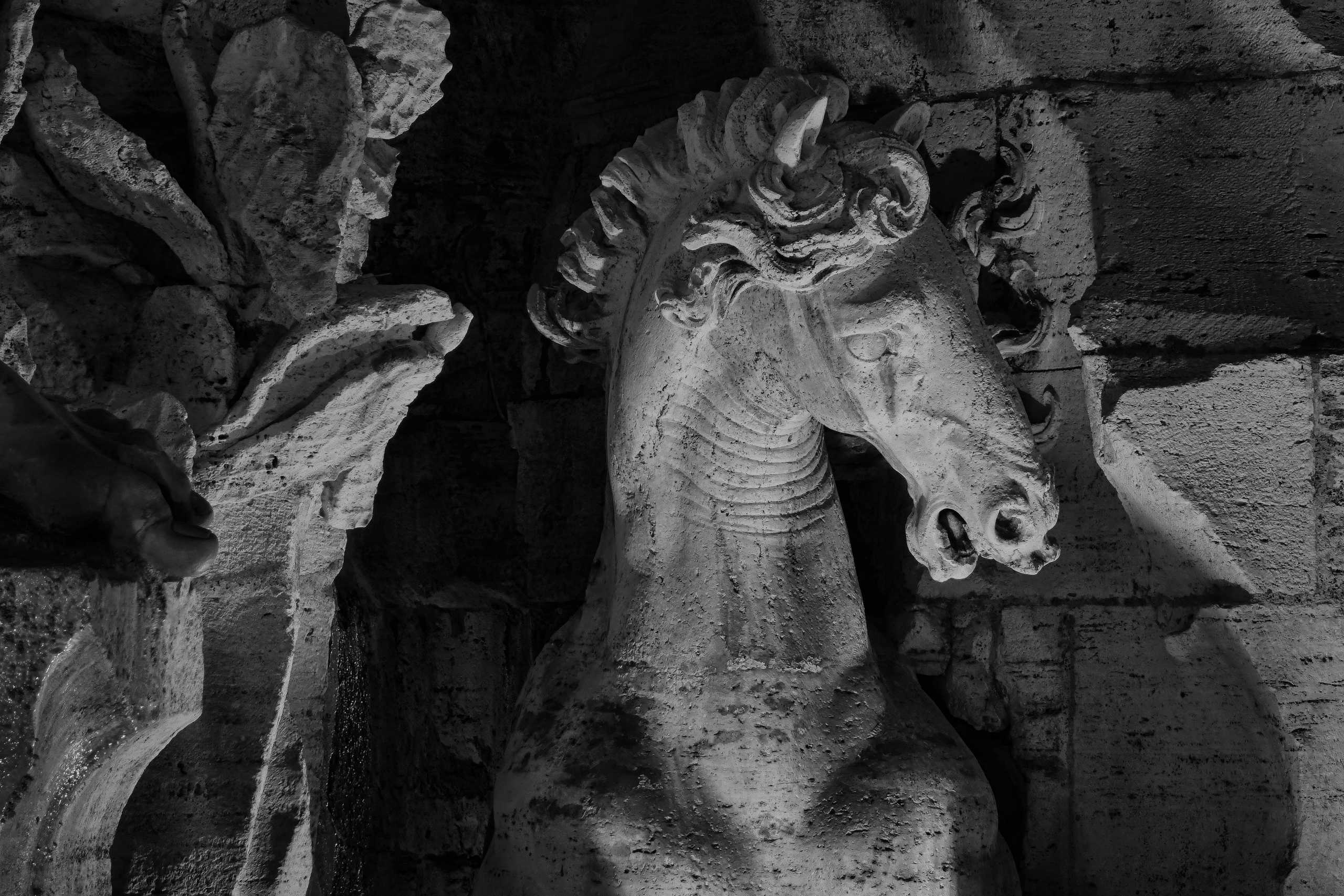 Rome, Italy – Fountain of the Four Rivers, Danube River sculpture by Gian Lorenzo Bernini in Piazza Navona, Roman Baroque marble detail captured in black and white fine art photography. Rome, Italy – fine art photography by Eduardo Bartoli.