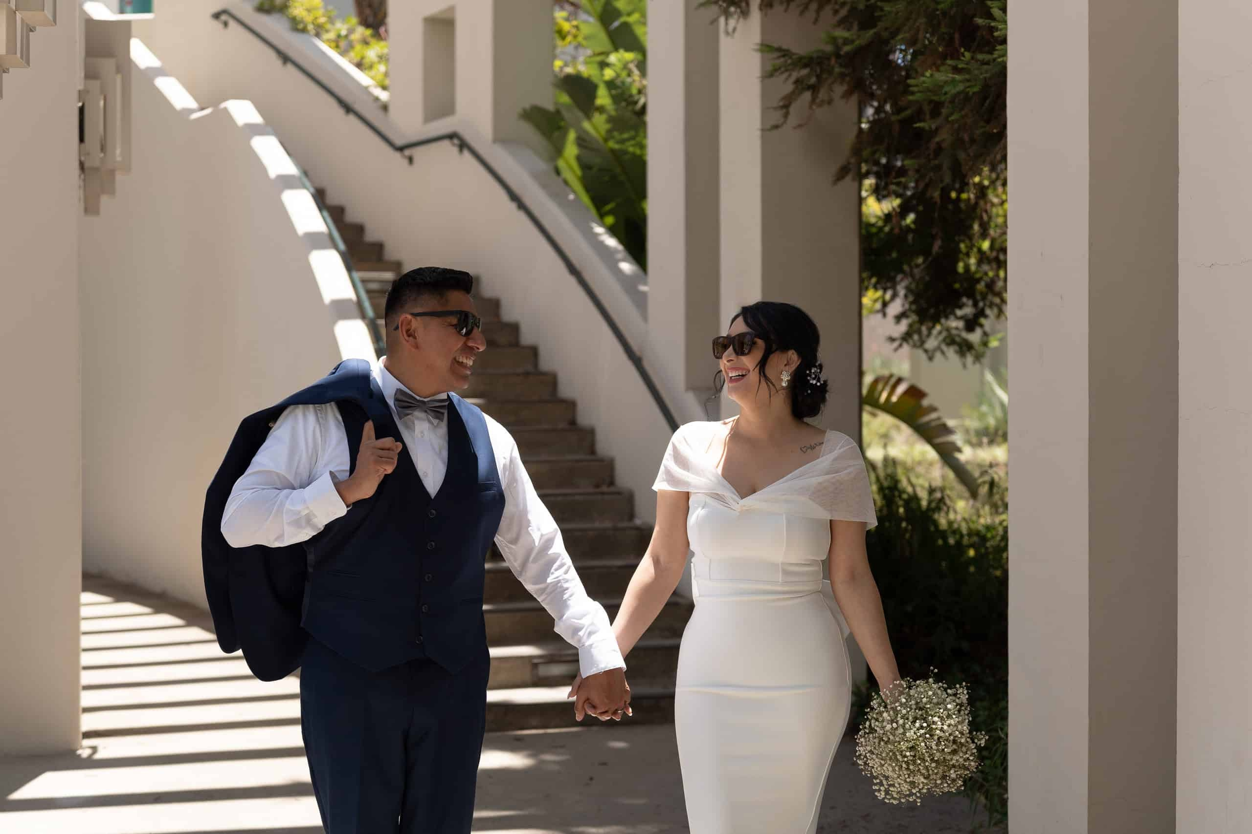 Newlyweds walking down curved staircase in Los Angeles