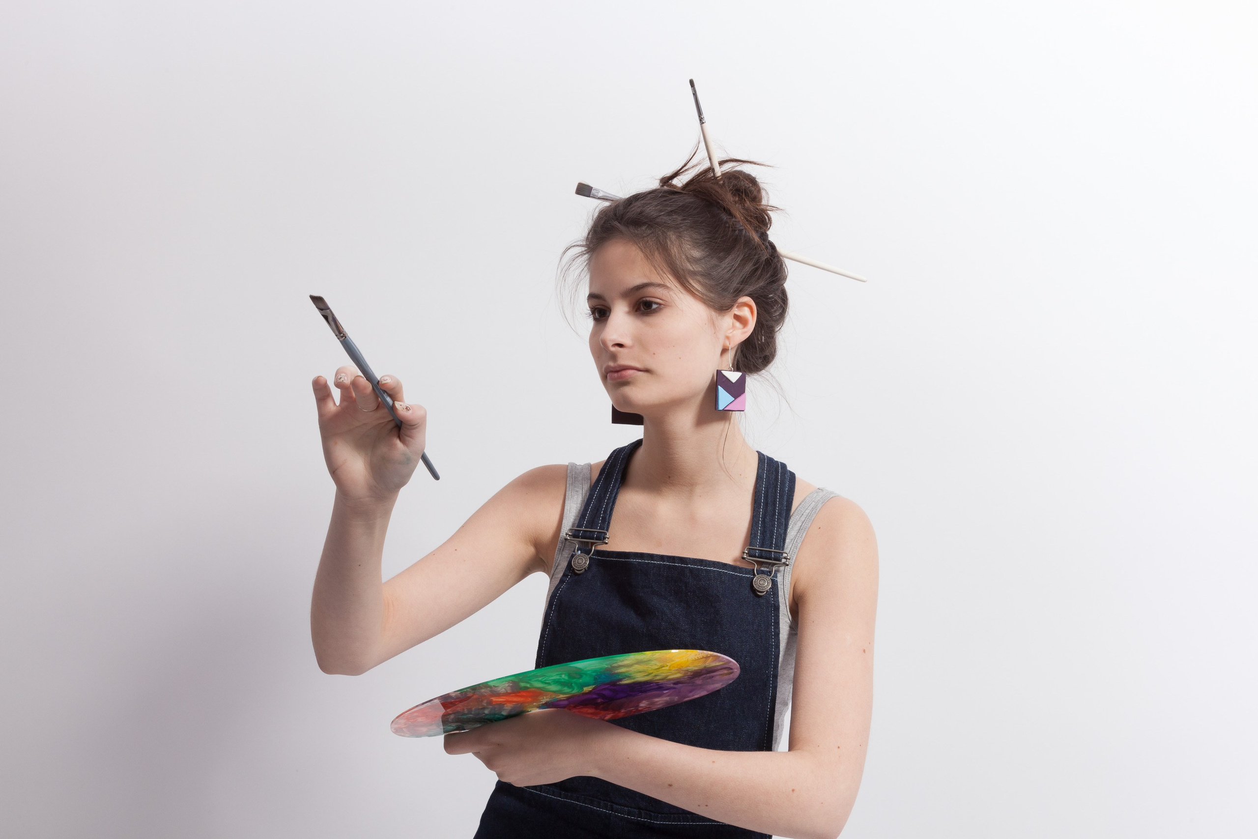 Portrait of a young artist girl on white studio background - photographer Andrey Dunin