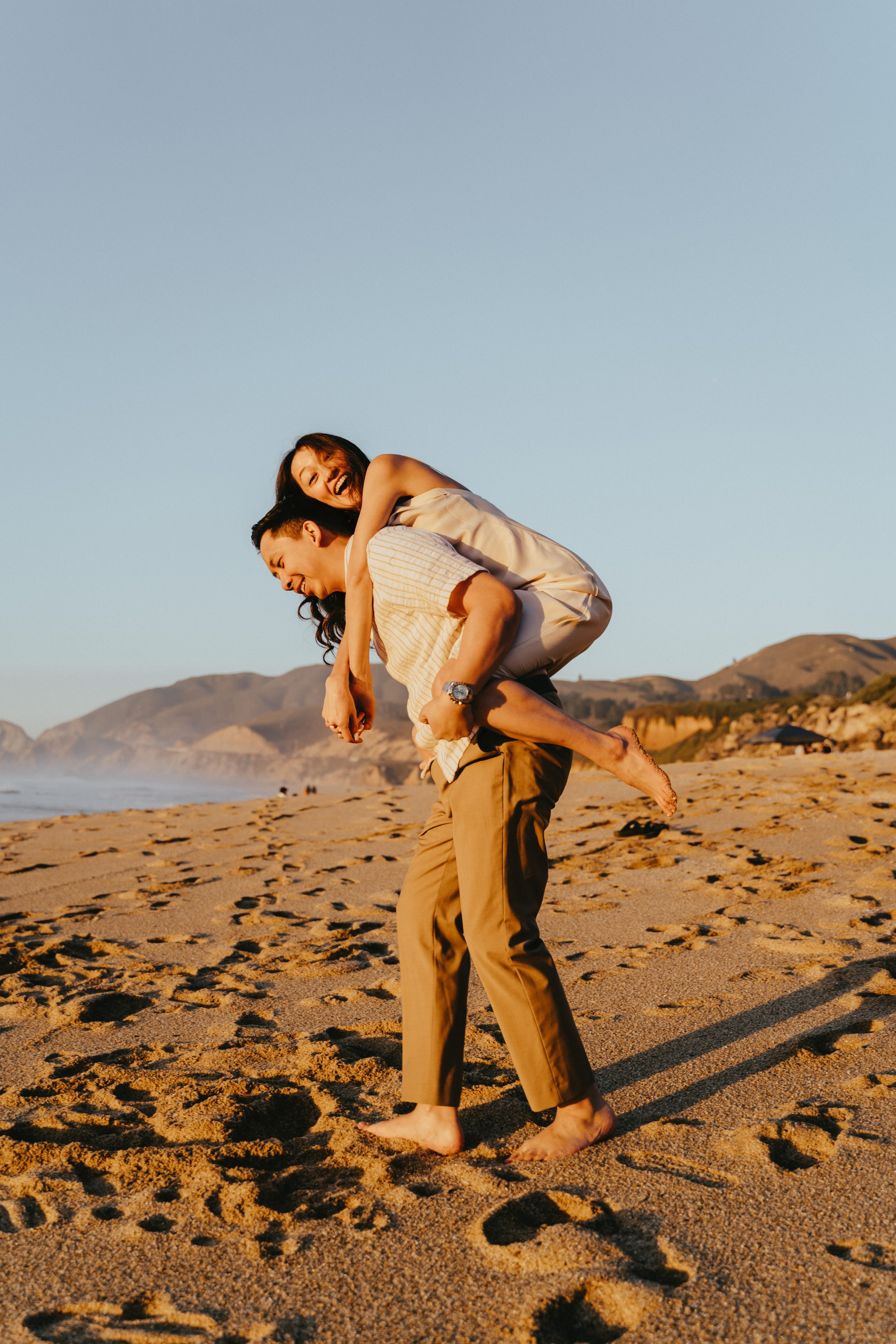 A photo shoot on the San Francisco beach at sunset. Engagement session. 
