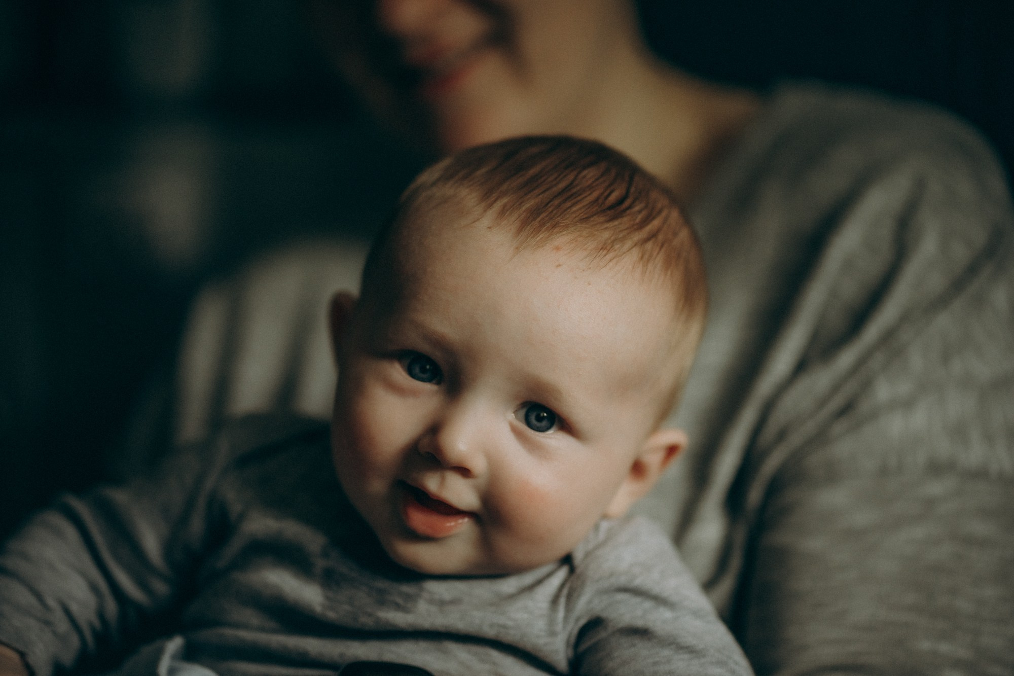 Малыш в объятиях родителей, улыбка — семейная фотосессия дома, детская фотография