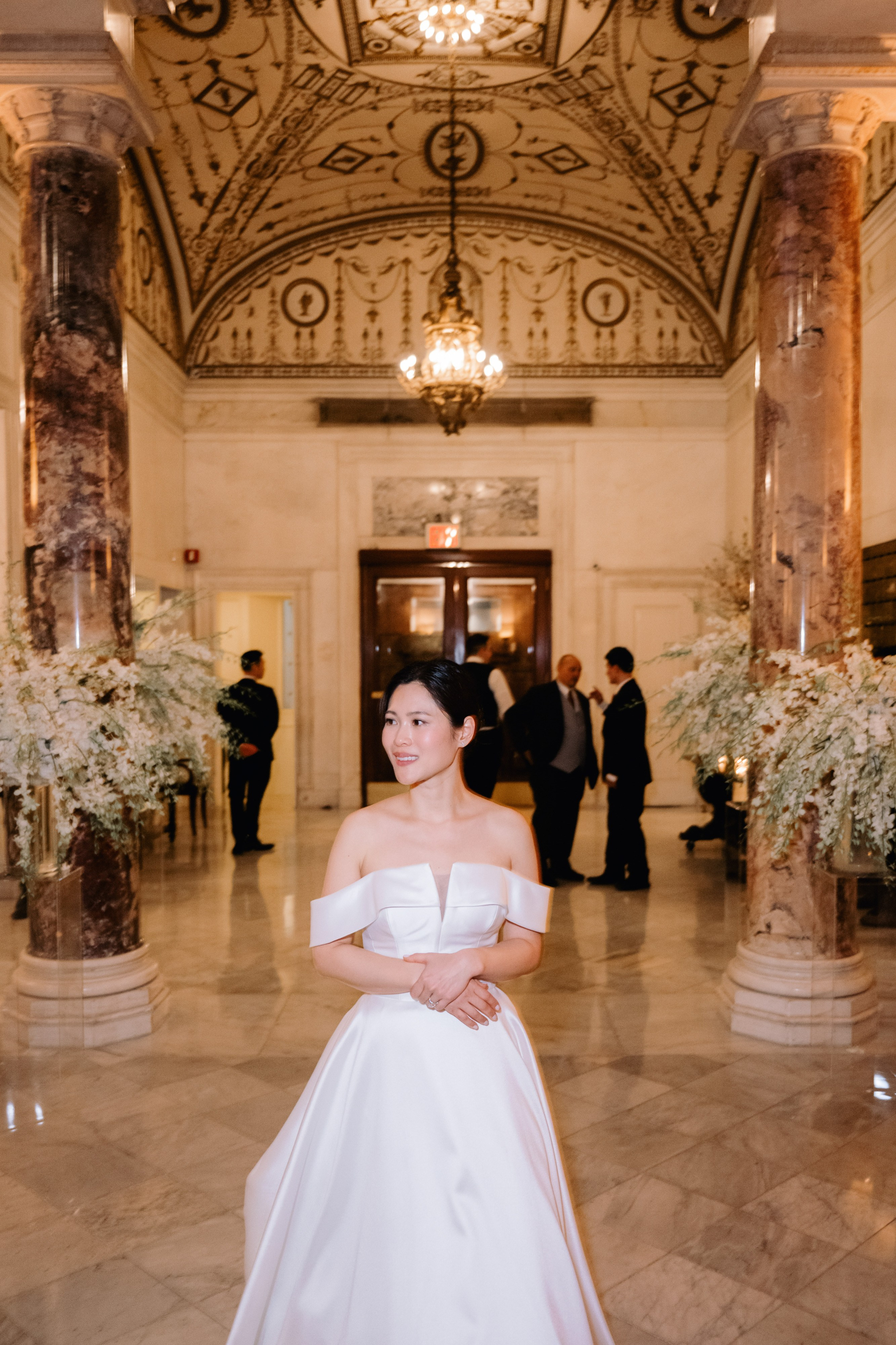 a woman in a white dress standing in a room