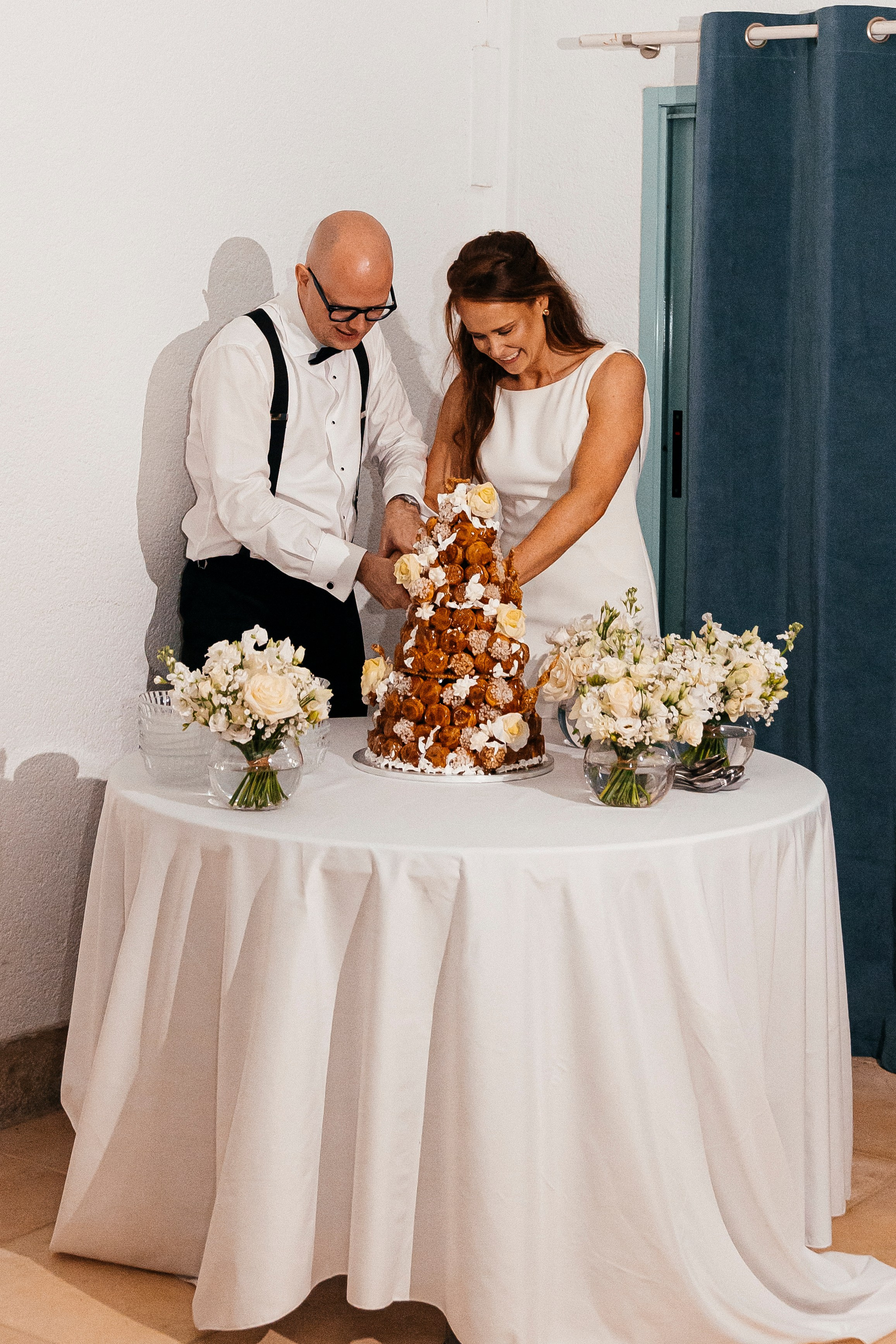 Bride and groom cutting a tower of cheesecake instead of a wedding cake
