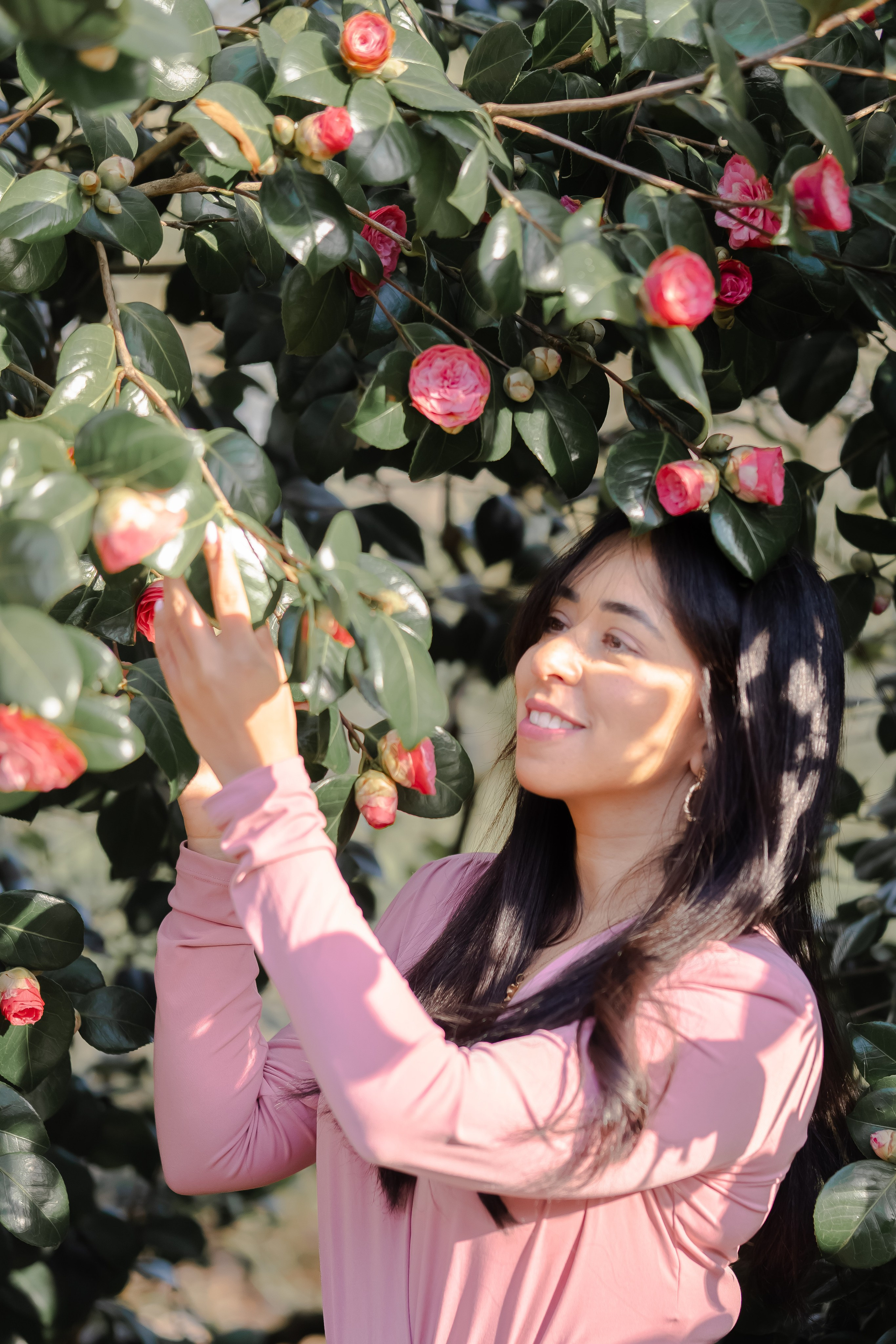 girl standing and holding a flowerin a garden in Netherlands