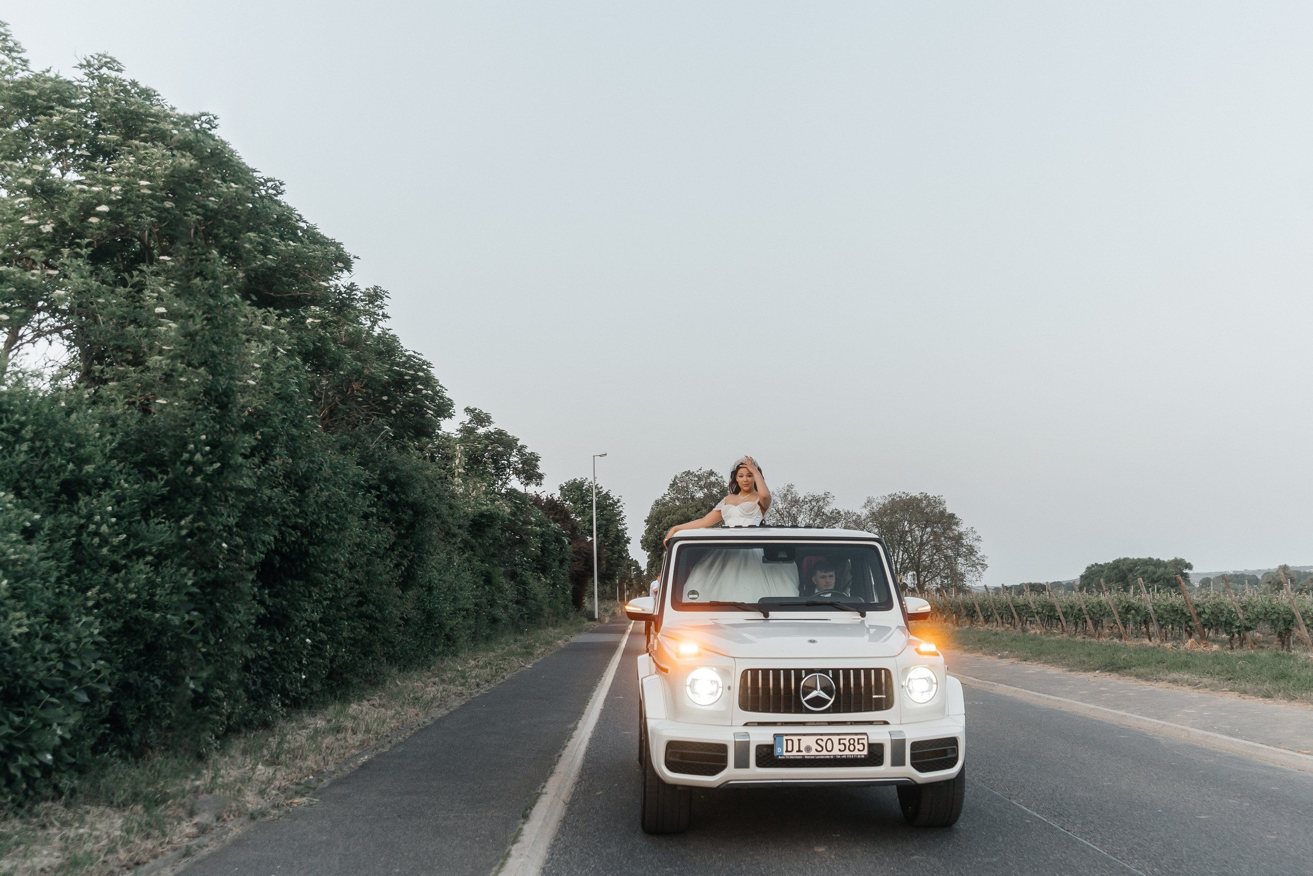 couple with g-wagen on the road