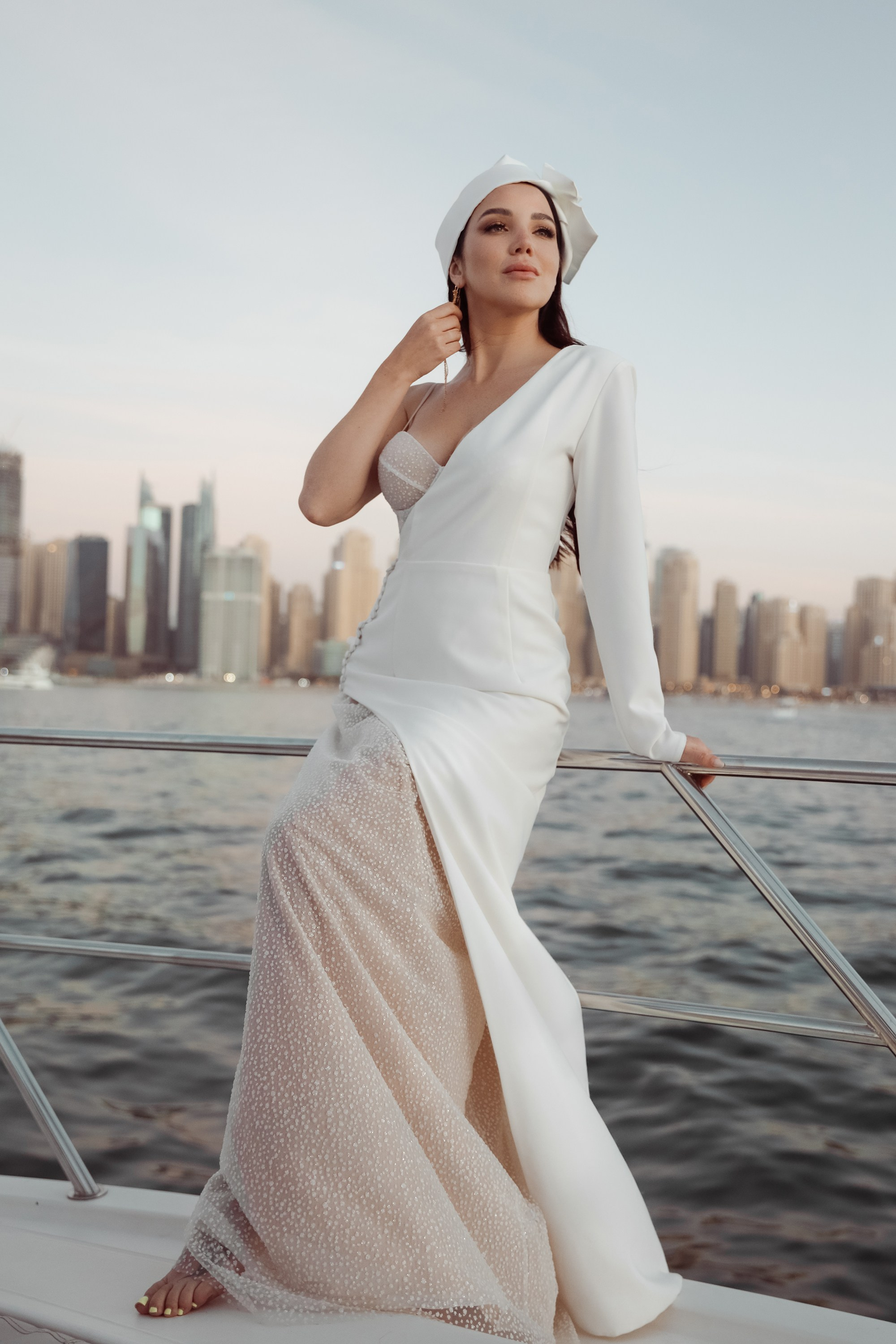 A woman smiles softly on a yacht, her portrait capturing her natural beauty and the tranquility of the ocean surrounding her. Dubai, United Arab Emirates
