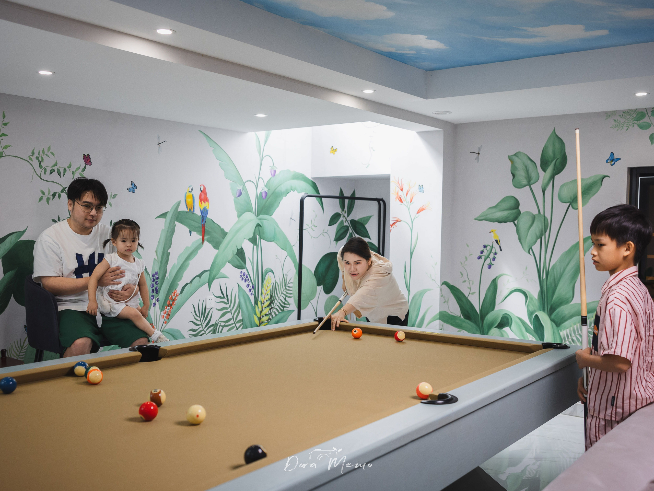 Documentary family photo in a Shanghai basement pool room where parents and children spent time together.