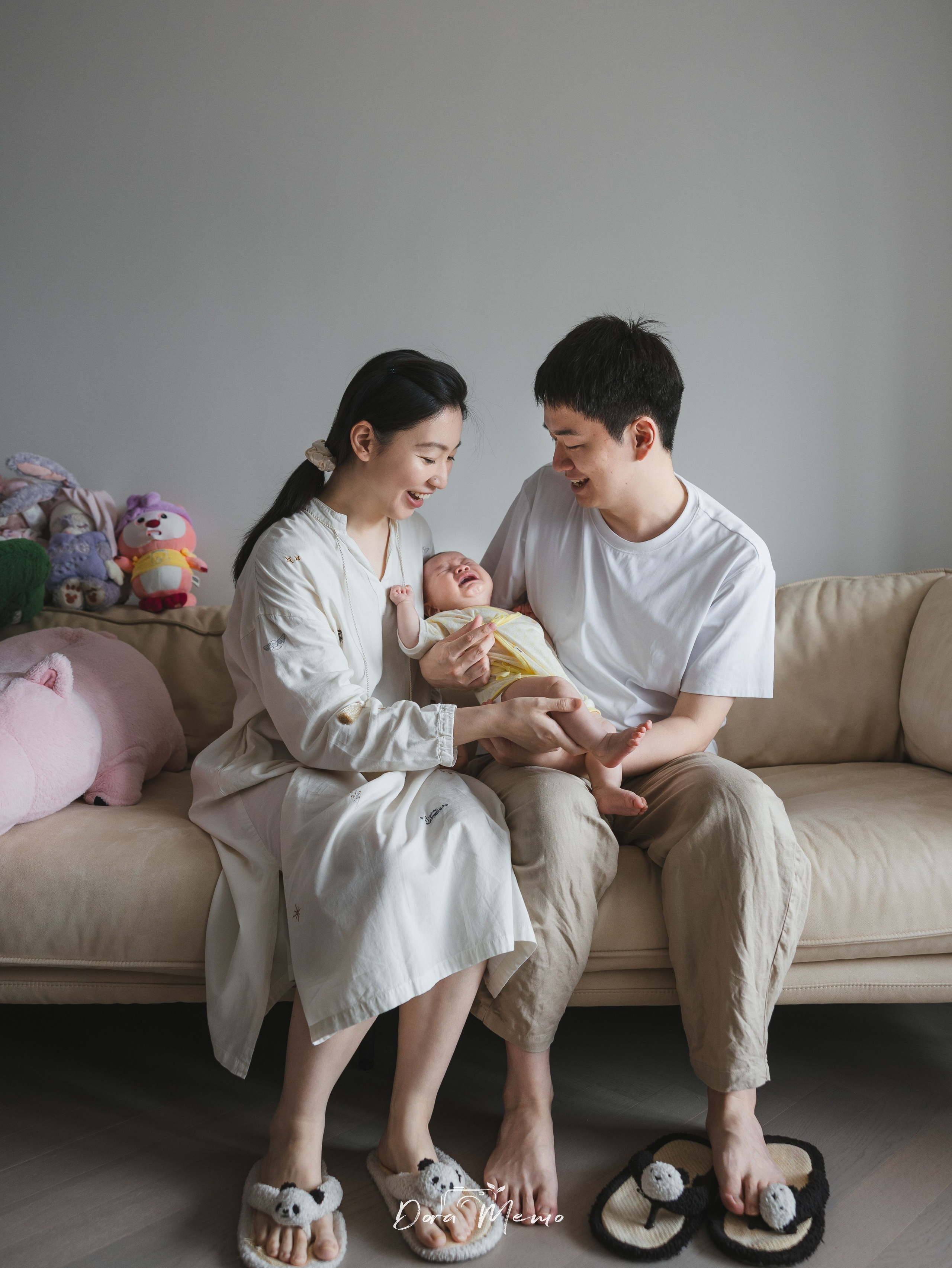In a family photoshoot, the mother and father look very much in love.