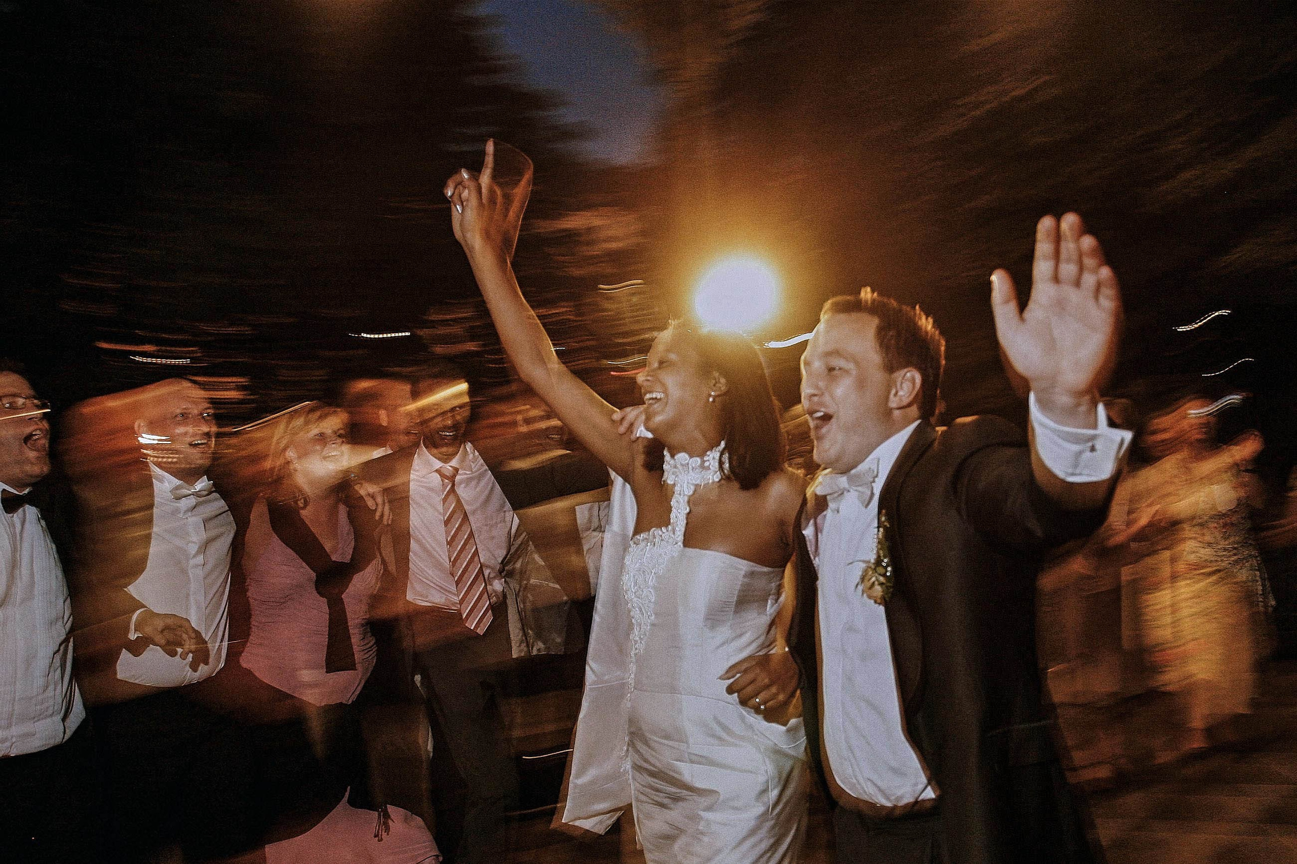 A Dutch bride & groom perform a vivacious 1st dance against the swirling background of their applauding and waving friends at the Palace Zofin in Prague. 