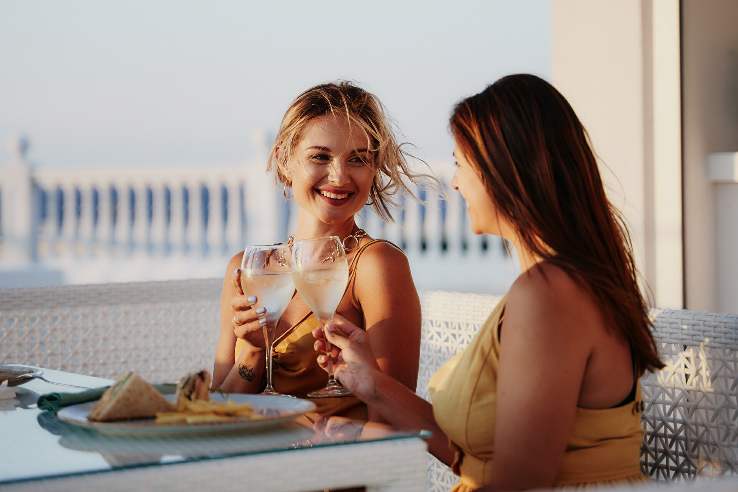 Two women enjoying drinks at rooftop restaurant