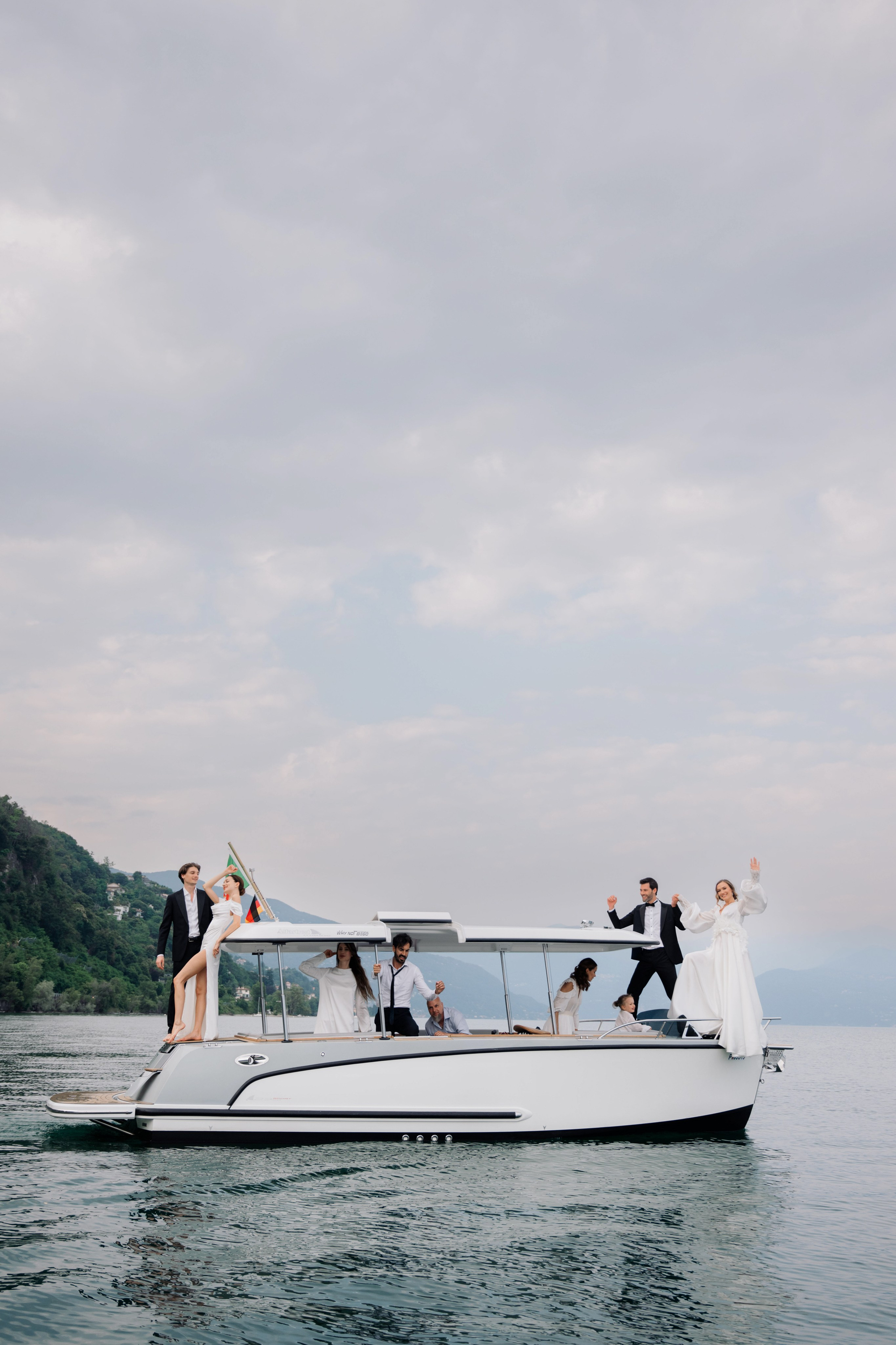 a bride and groom on a boat in the water