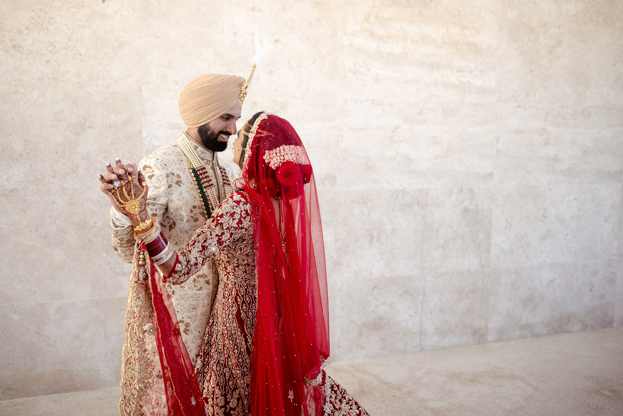 Indian wedding couple in Los Cabos – bride and groom in traditional attire dancing during luxury destination celebration