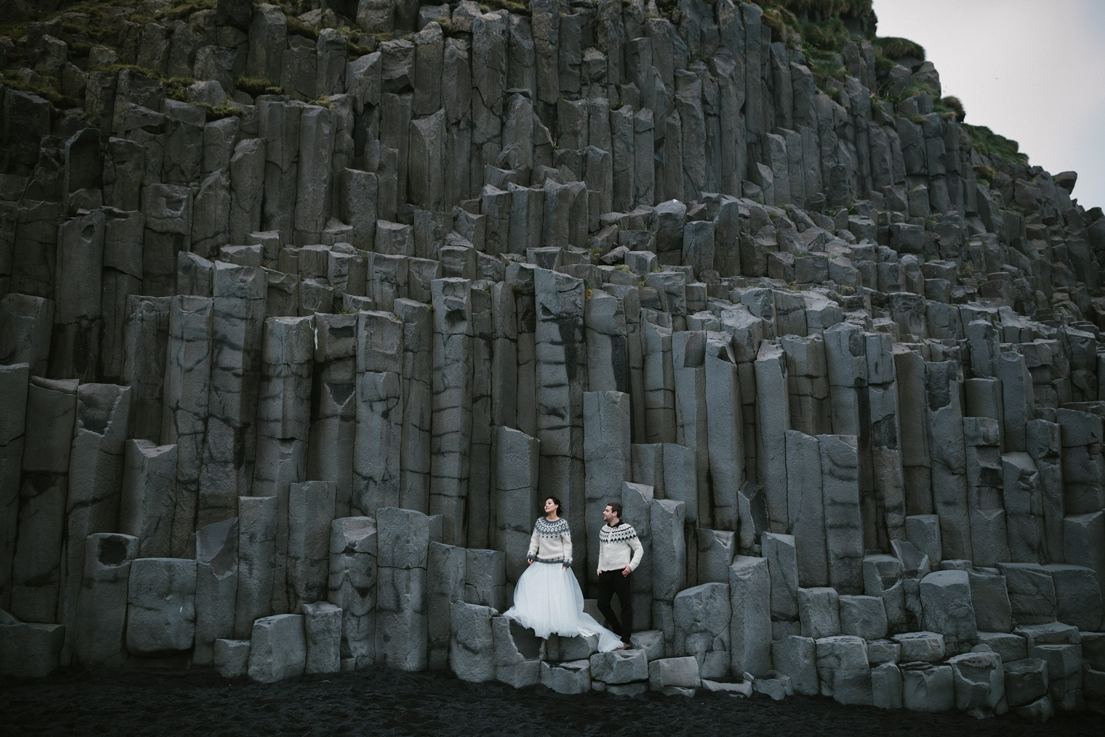 Together in front of the dramatic basalt cliffs on Iceland’s black sand beach