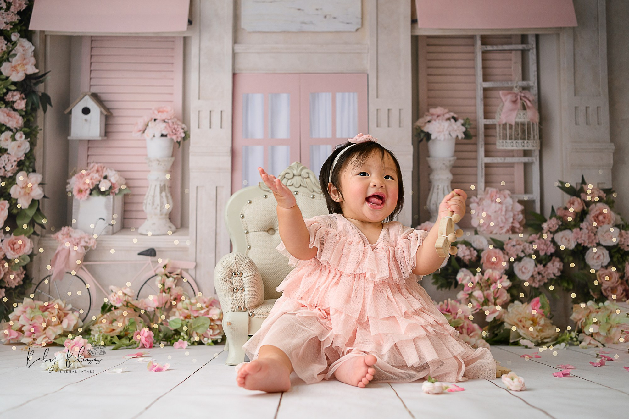 floral and dusky pink themed setup for one year old baby girl.