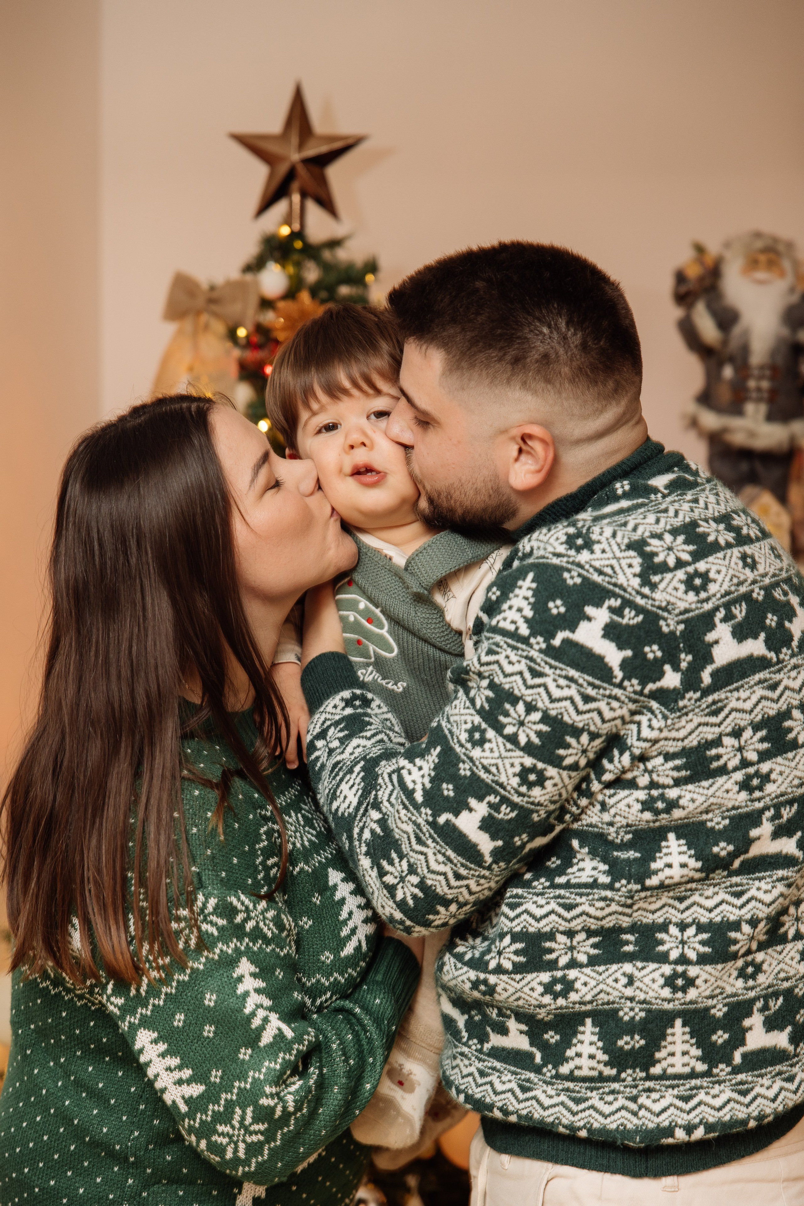 Couple with their child in Christmas outfits