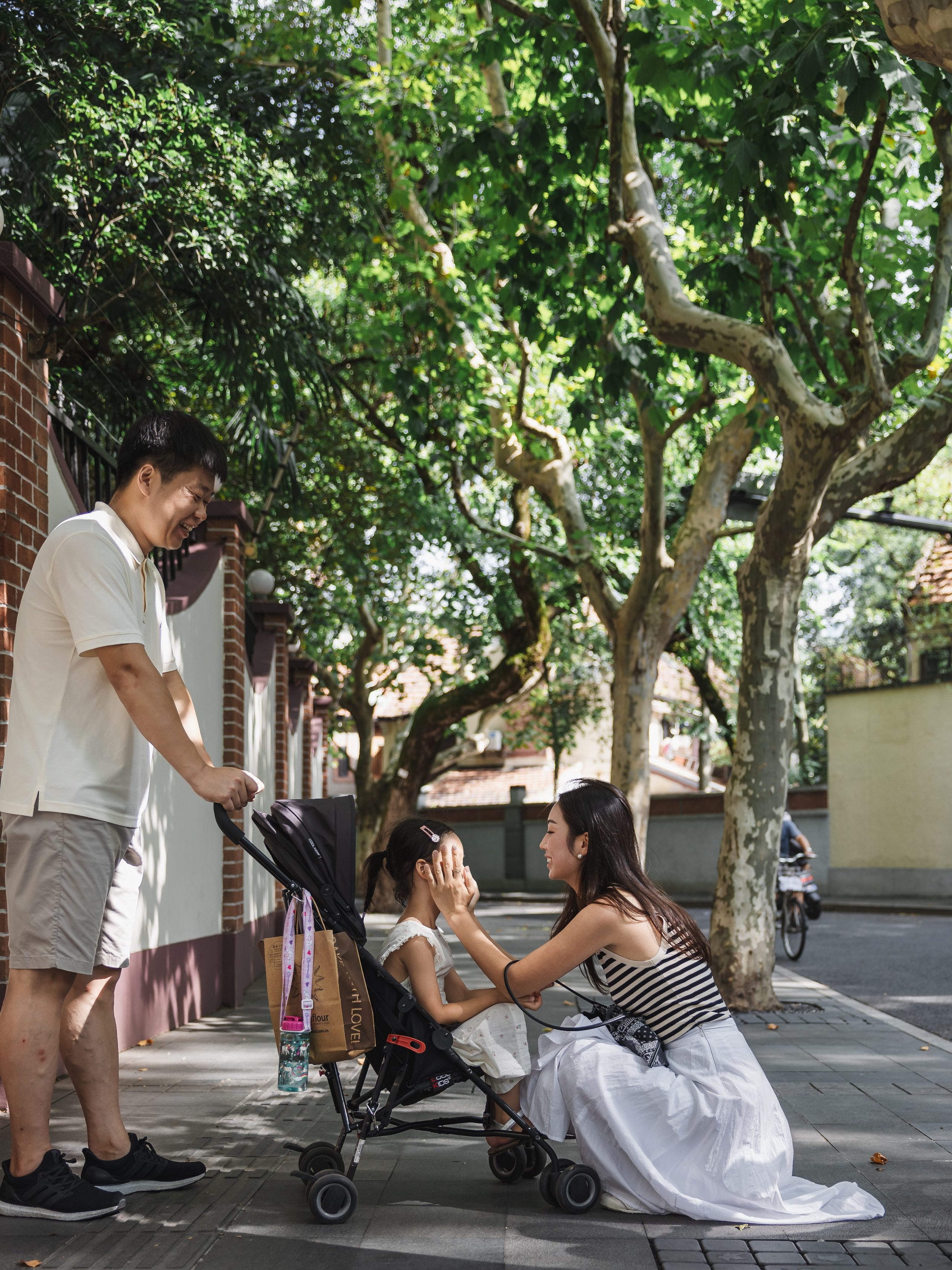 In the summer of Shanghai, in the former French Concession, I captured a moment of interaction between a family of three on the street.