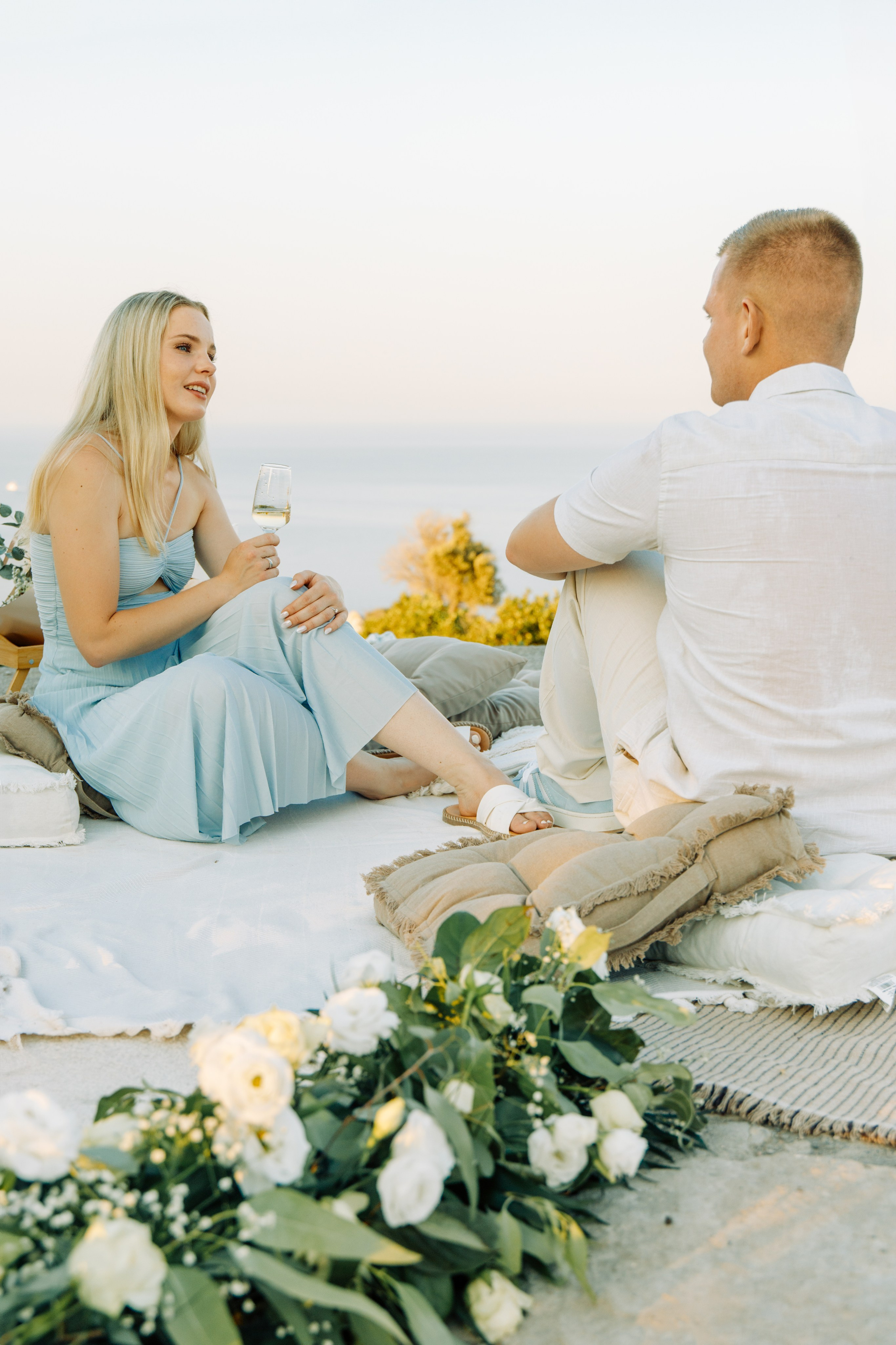 Marriage proposal in Rhodes 💍 couple at Profitis Ilias near Faliraki with sea view and romantic decoration at sunset in Greece.