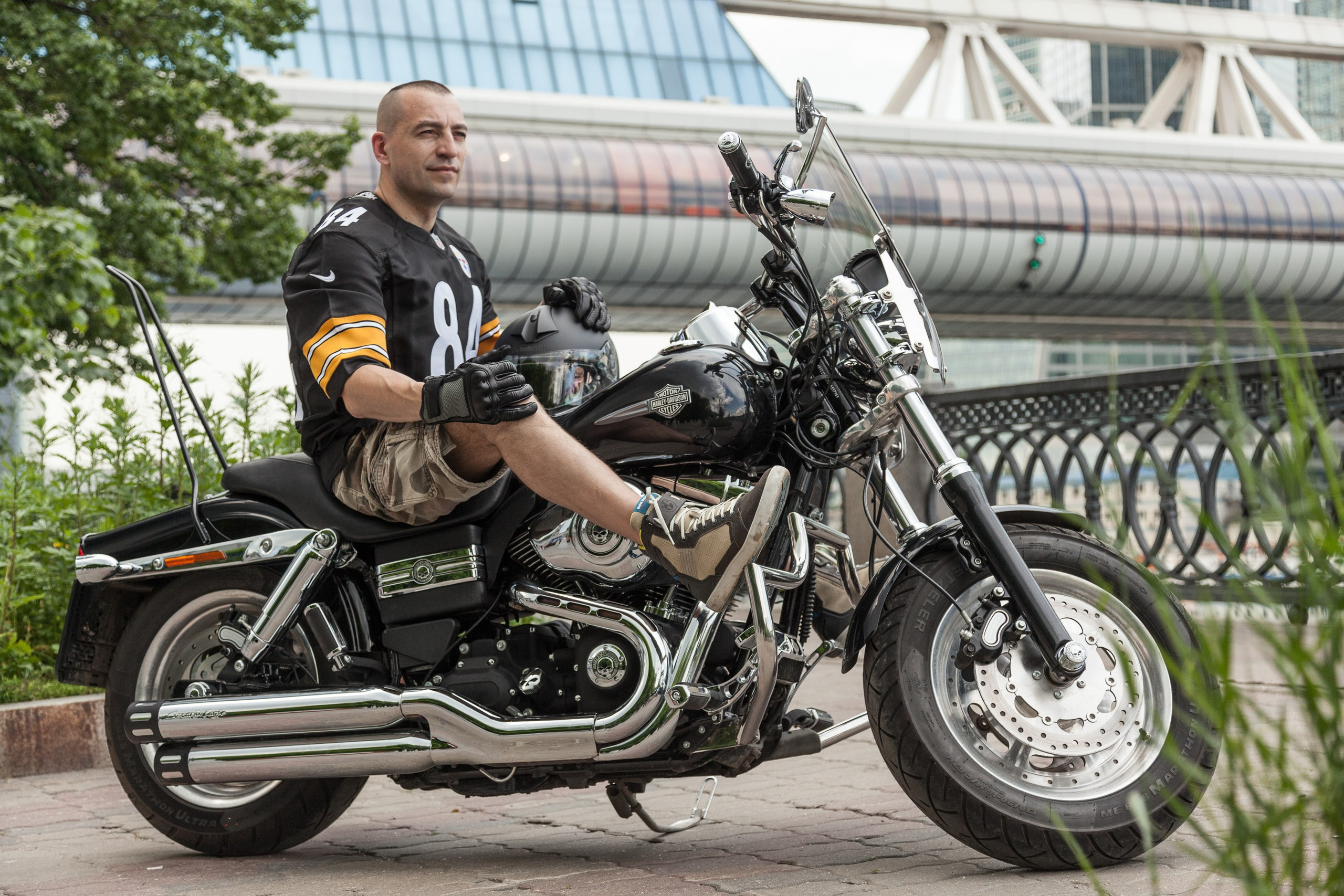 Location portrait of a biker on a Harley Davidson motorcycle in city landscape - photographer Andrey Dunin