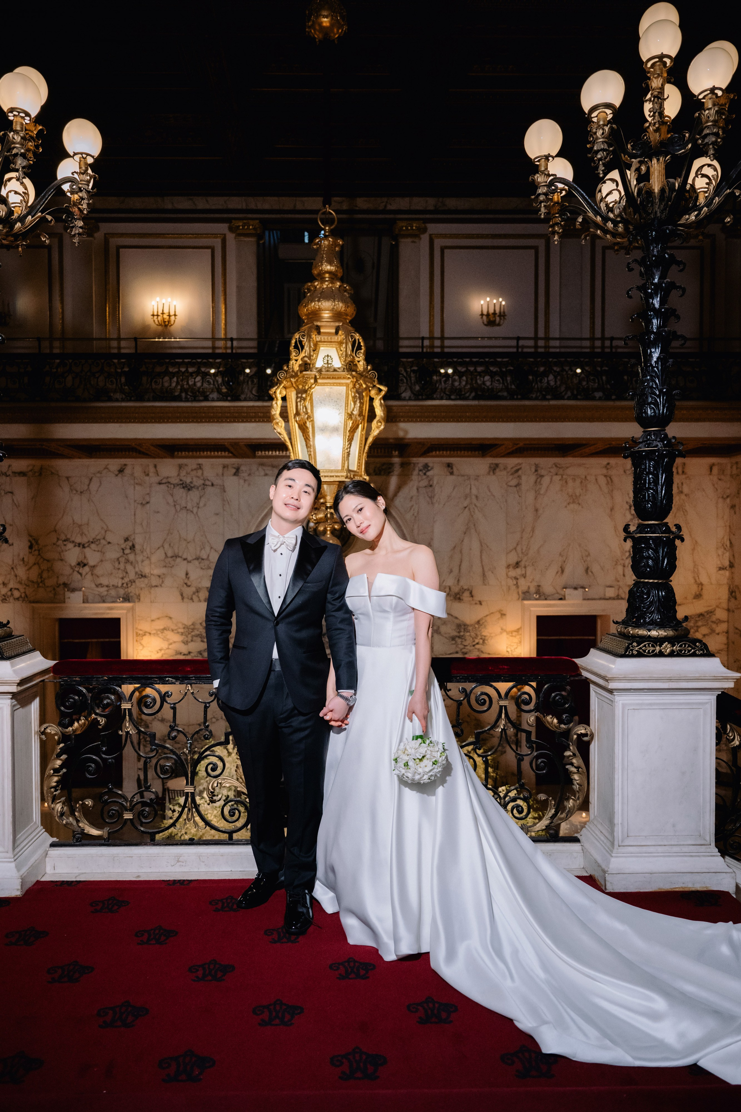a bride and groom posing for a photo in a hotel