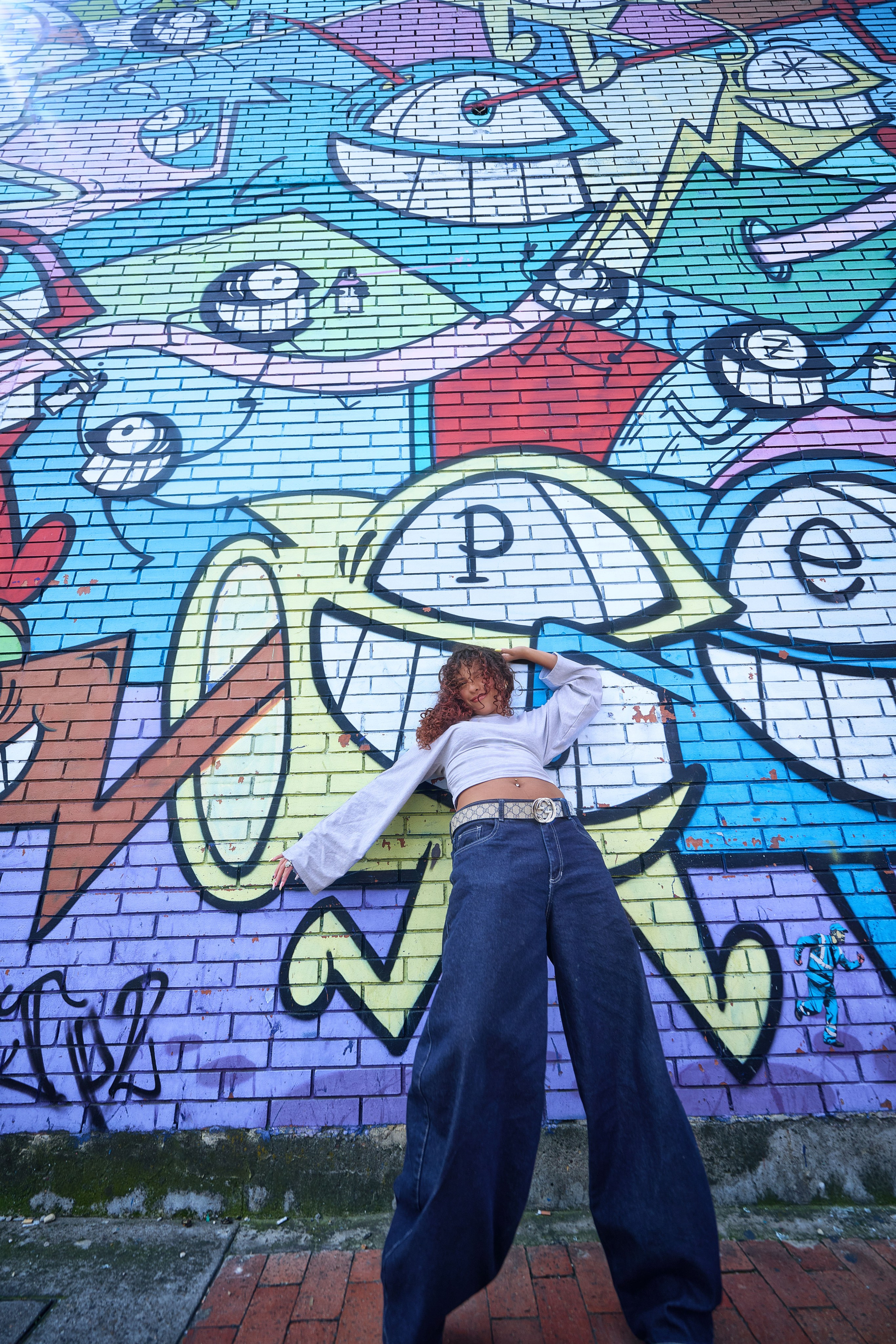 Ivanna posando frente a murales coloridos en Distrito Graffiti para su sesión pre-XV