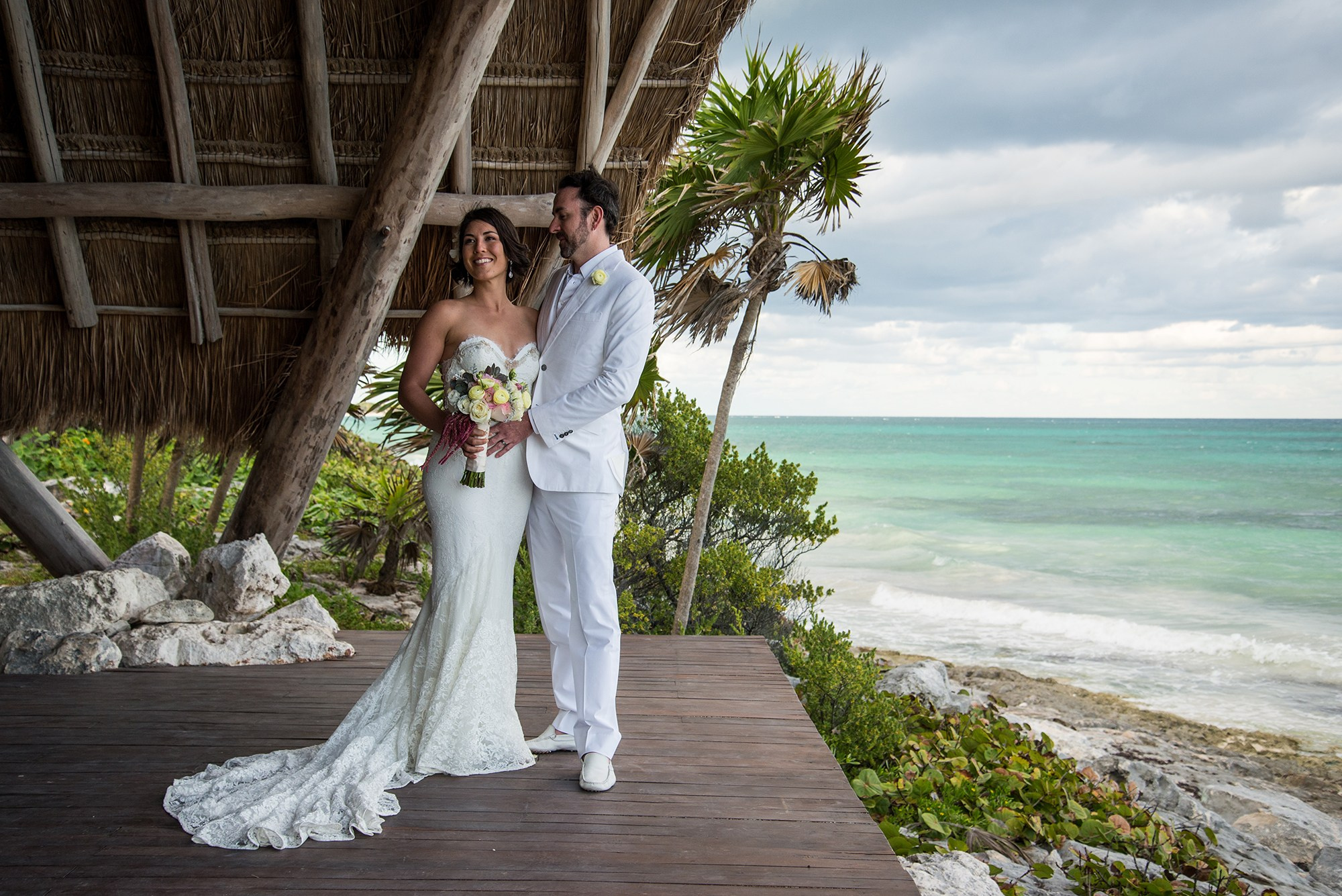 Post ceremony wedding portrait in Los Cabos – groom looking at bride with romantic sunset light