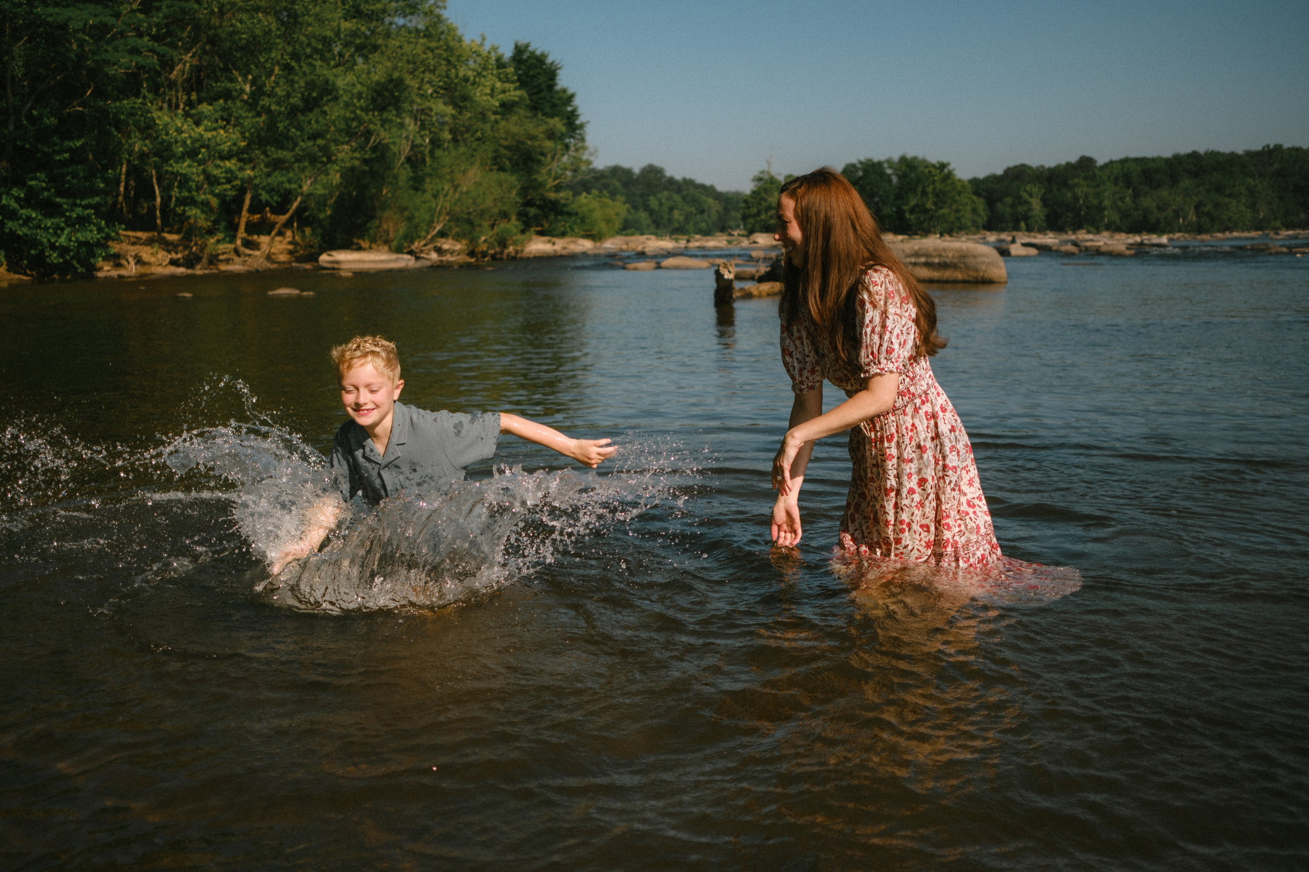 Beautiful, cinematic family portrait capturing a genuine, unposed moment on the river rocks in Richmond, VA