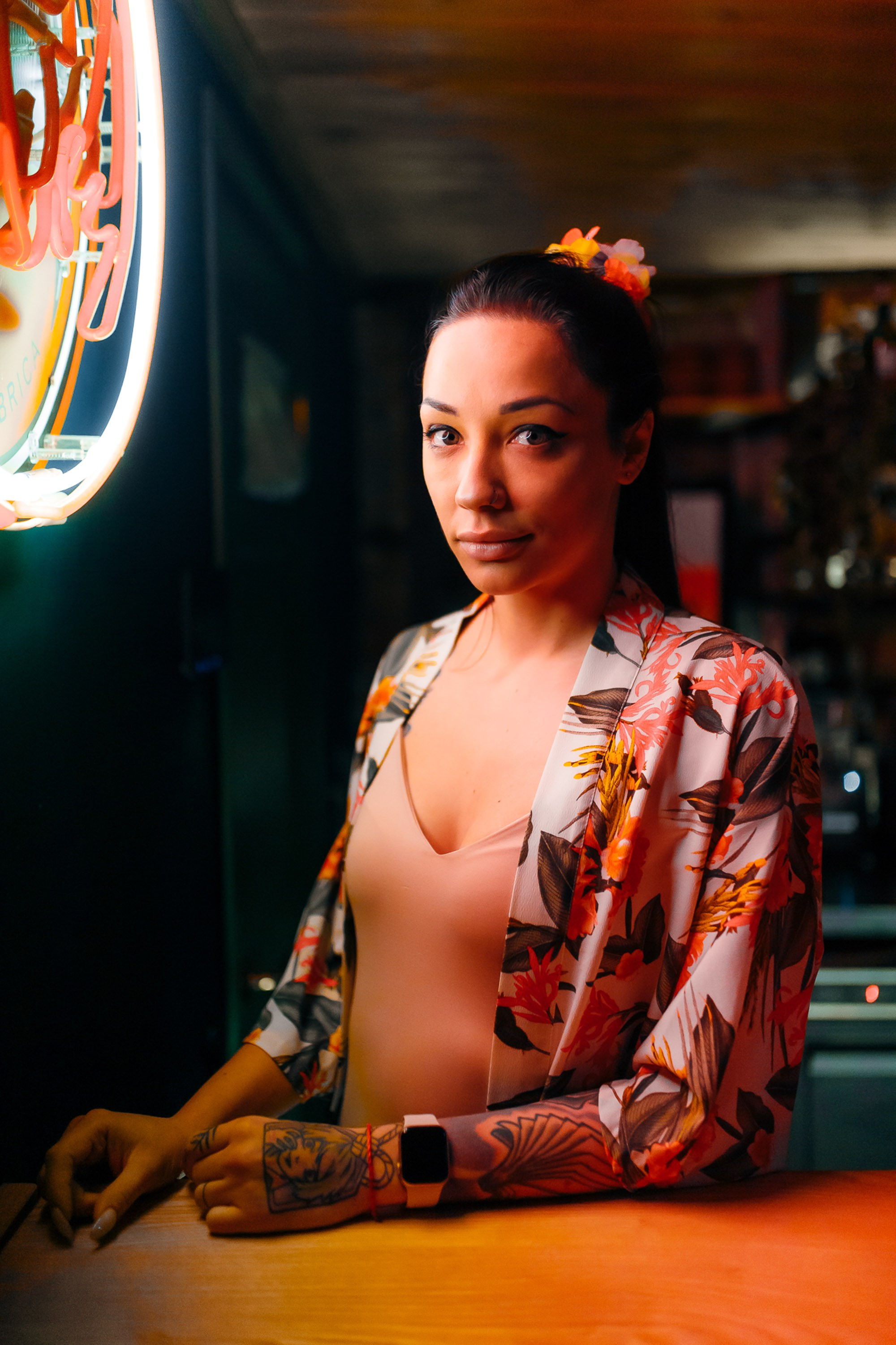 Woman portrait at the bar with neon light