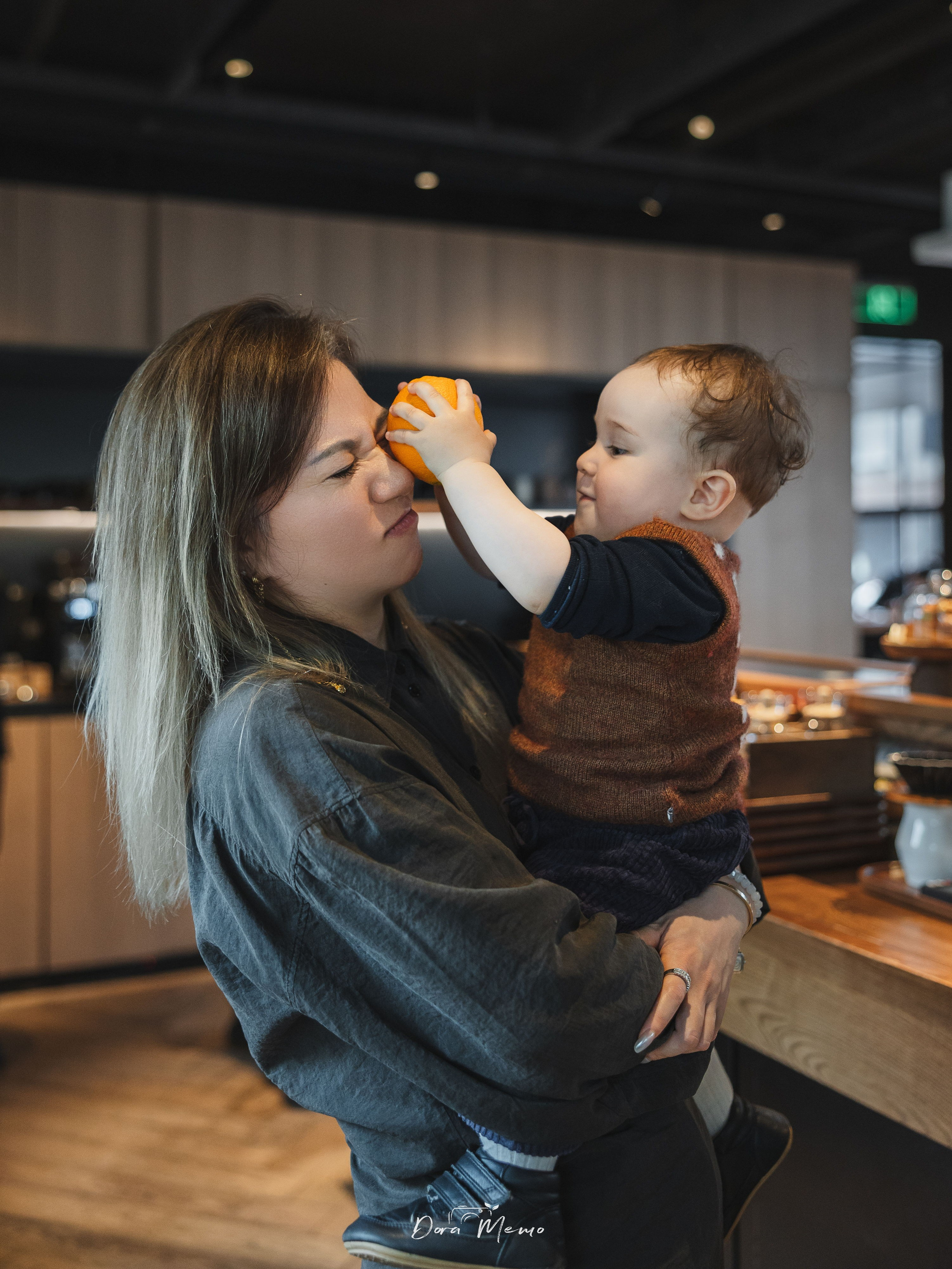 The one-year-old baby playing with his mom.