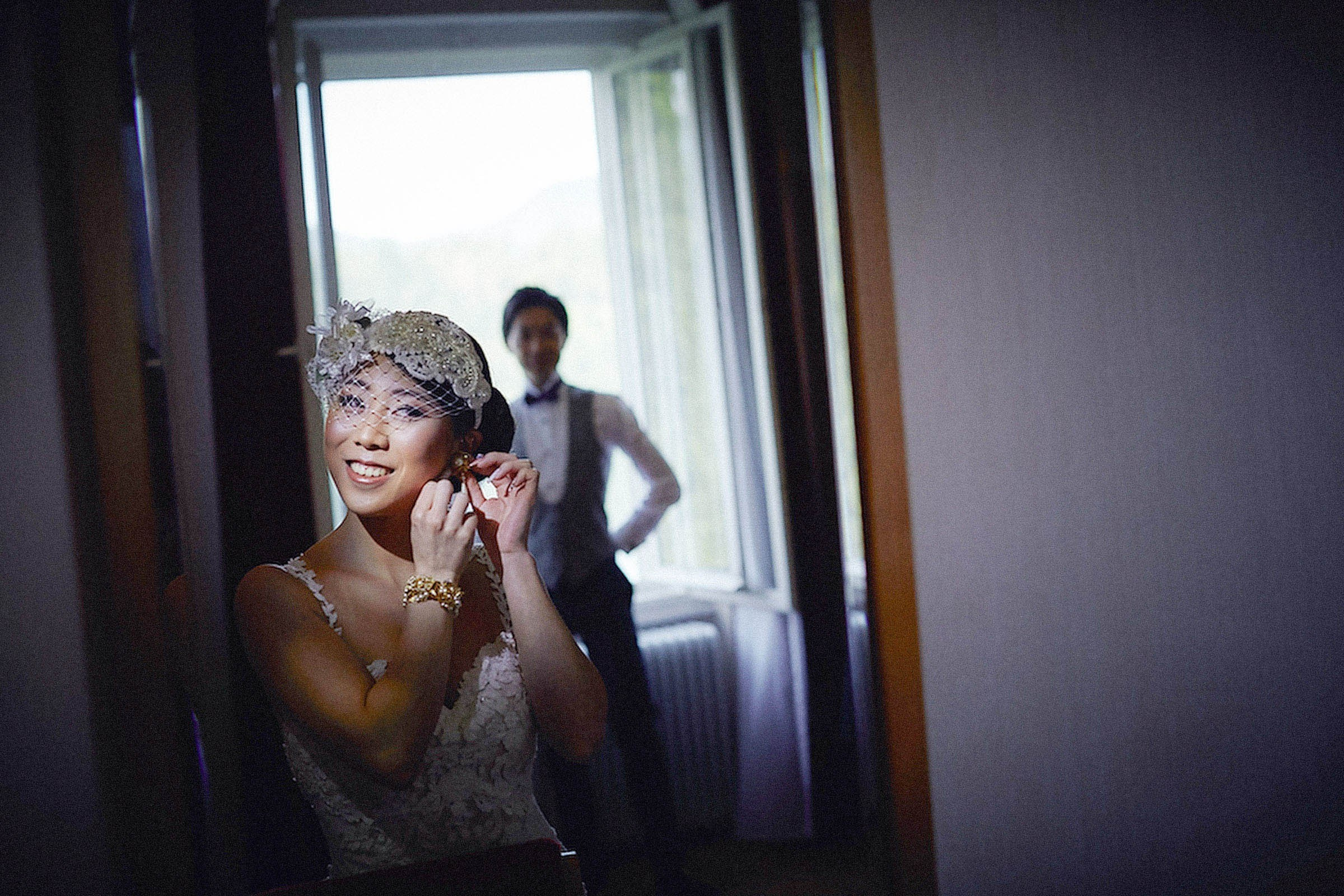 Japanese bride putting on earrings mirror reflection Vila Bled.