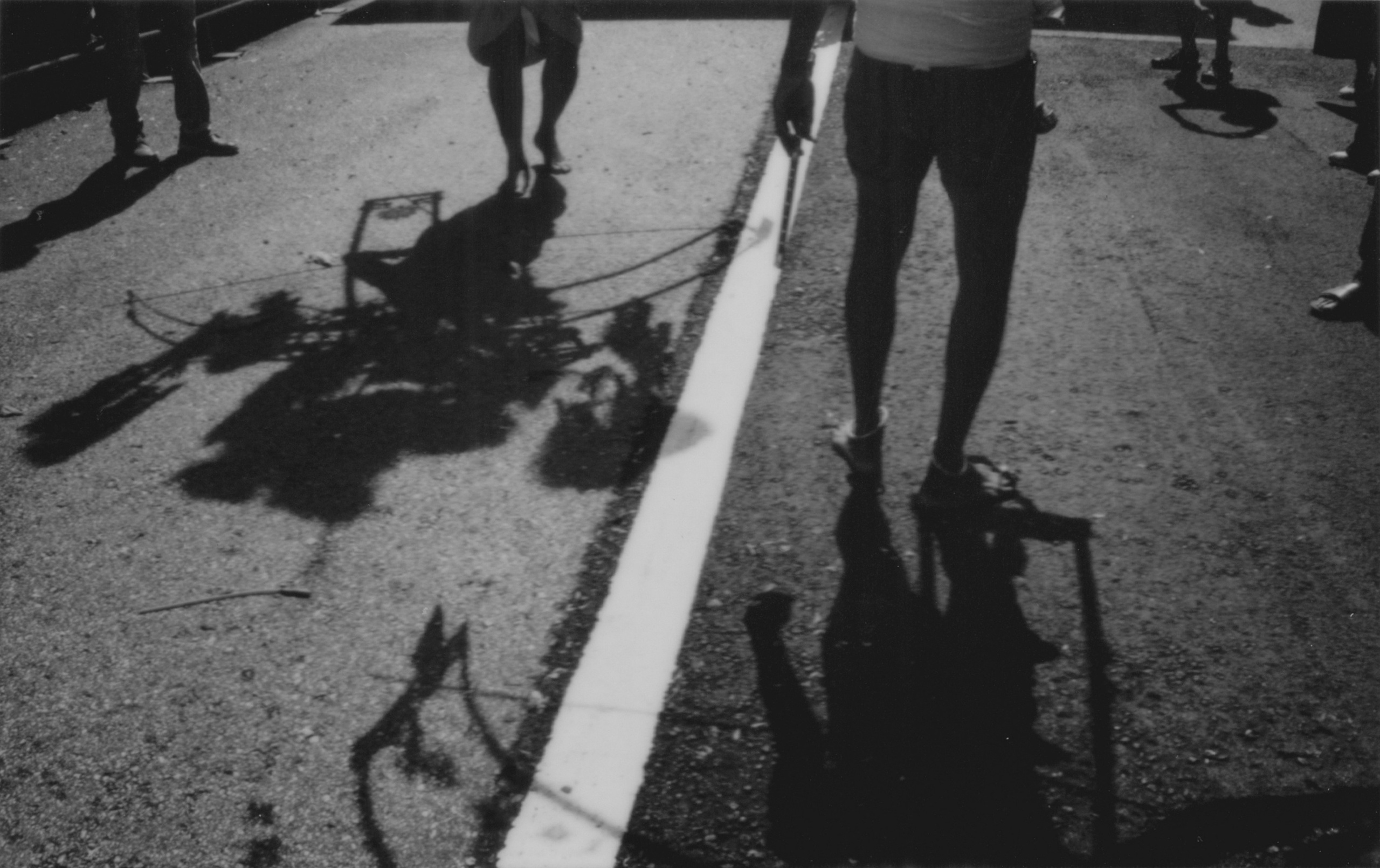 A compelling black-and-white photograph focusing on the dramatic shadows of kavadi bearers and their sacred structures during the Thaipusam procession in Singapore. The interplay of light and shadow creates a powerful visual narrative, emphasizing movement and devotion. This image highlights the photographer’s expertise in photojournalism and event reportage, capturing fleeting yet impactful moments—ideal for clients seeking artistic documentation of cultural or corporate events.