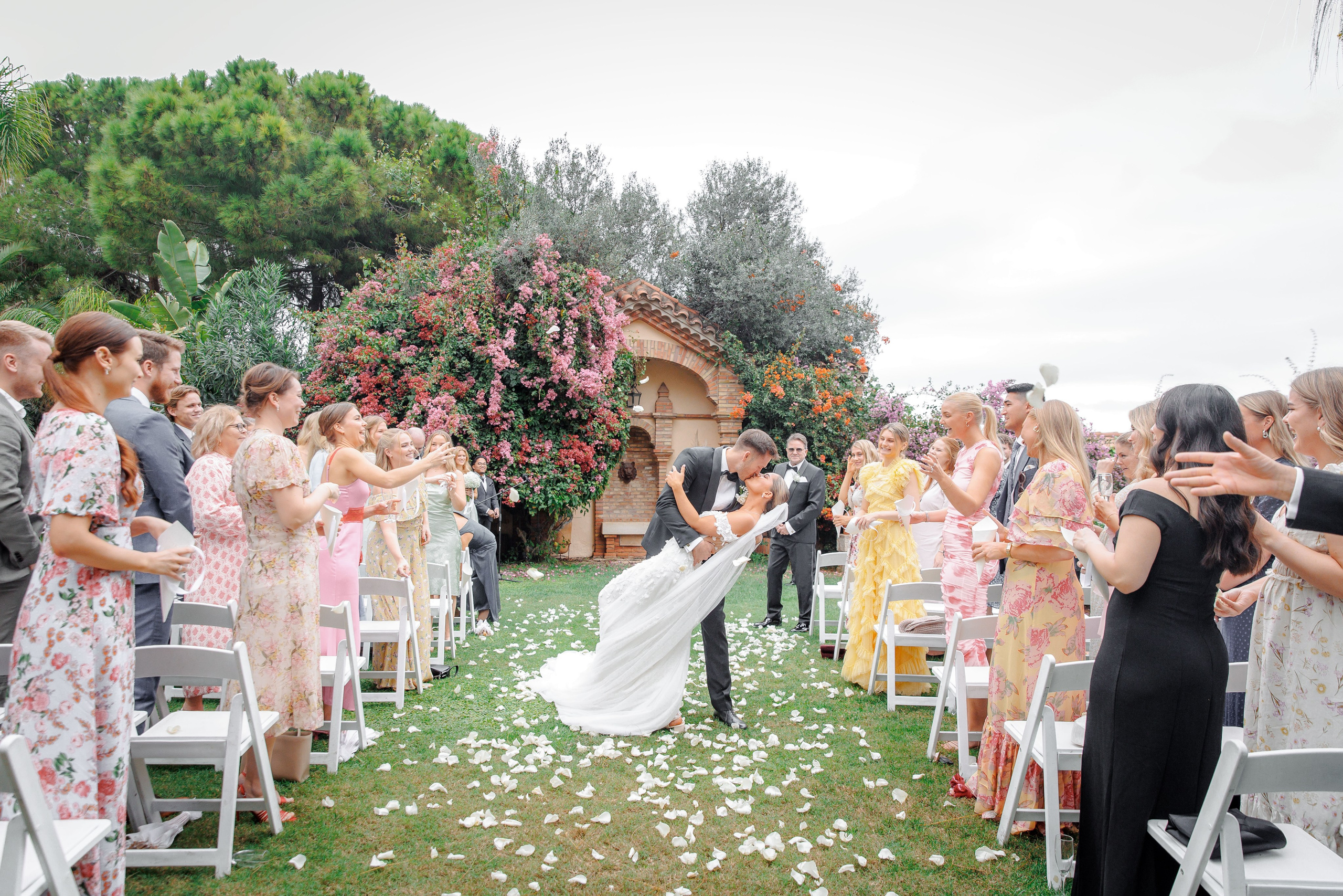 The groom kisses the bride after the ceremony in the wedding venue in Barcelona.