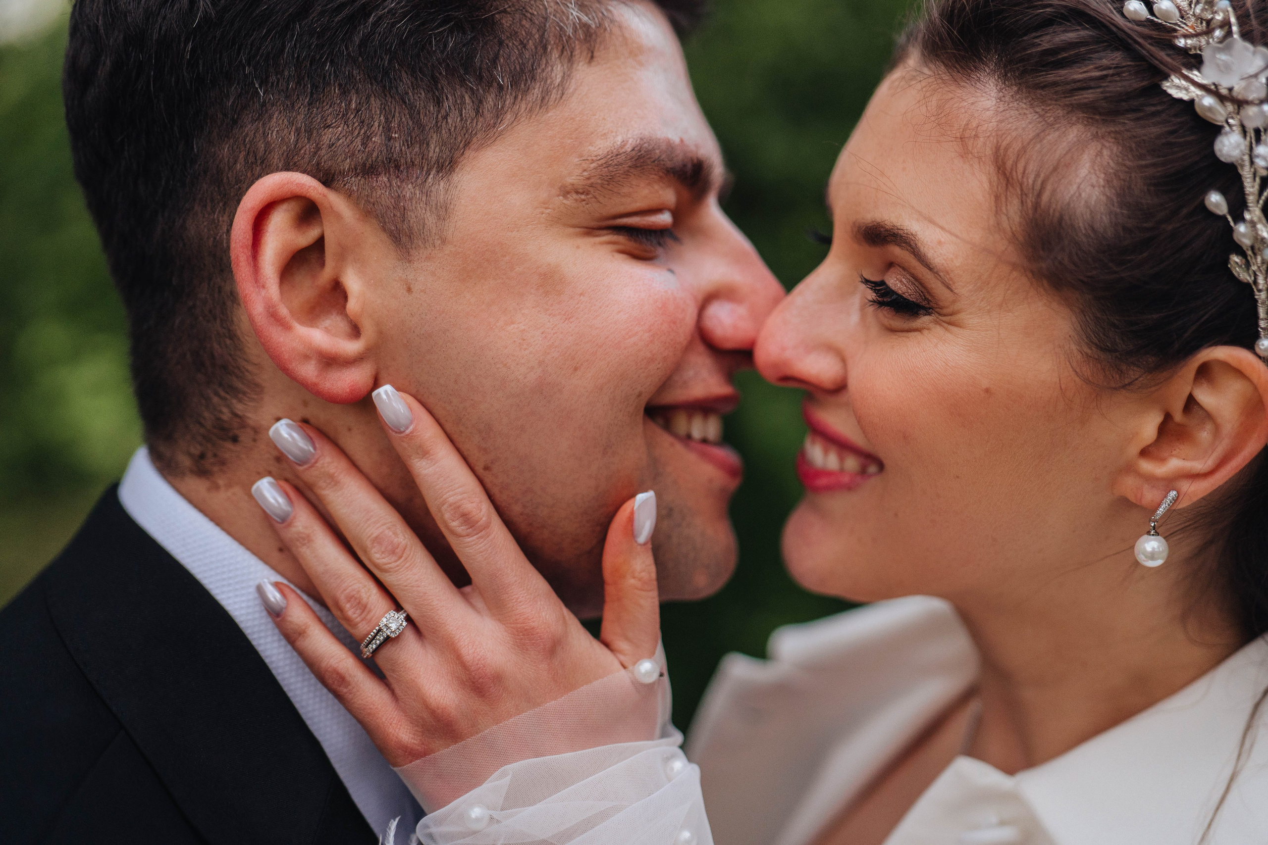 close up of bride and groom kissing and smiling