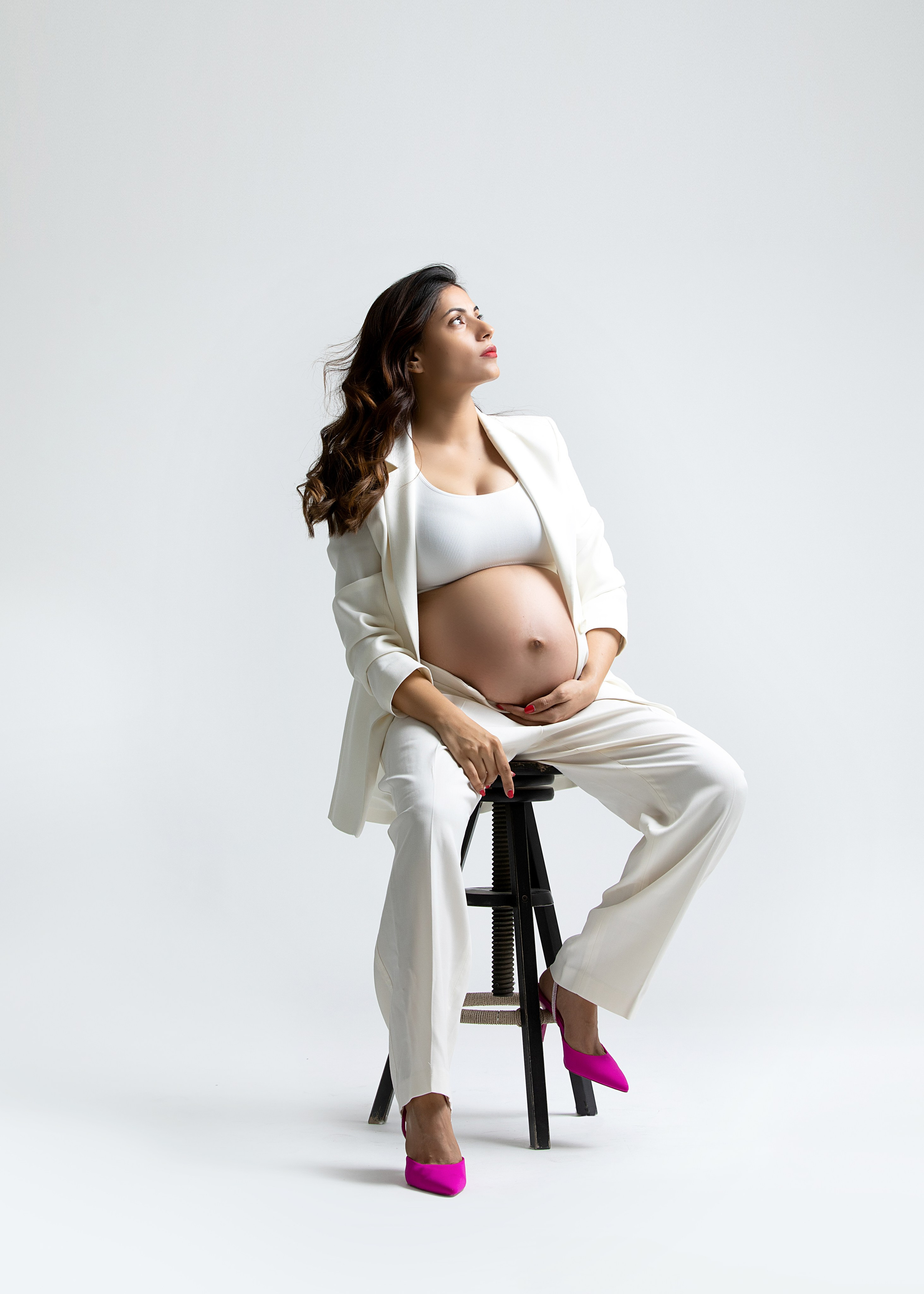 Upplev en elegant fotossession för din graviditet, med professionella bilder och vackra klänningar tillgängliga för uthyrning.