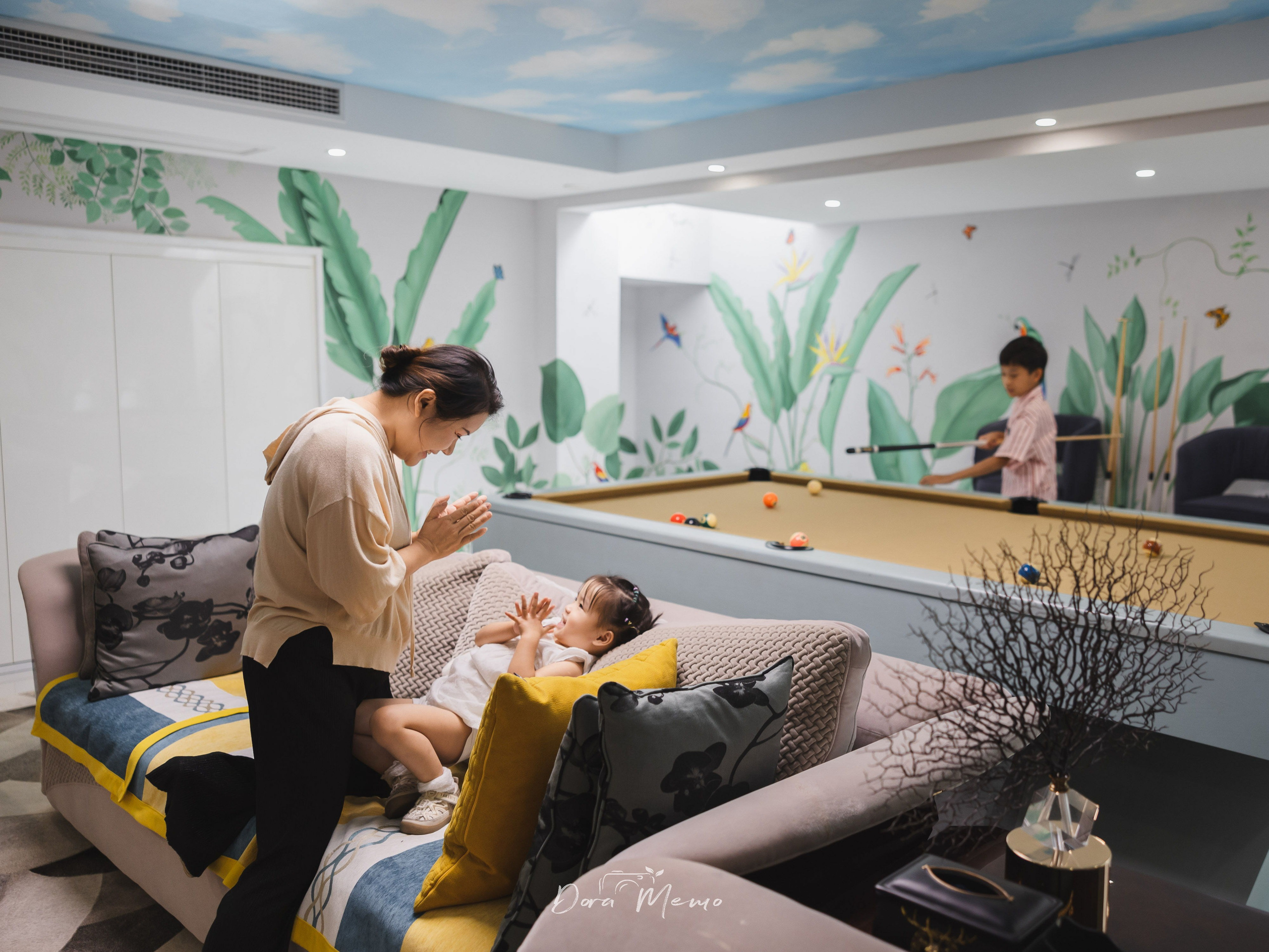 Mother and daughter share a quiet moment in the family media room before leaving their Shanghai home.