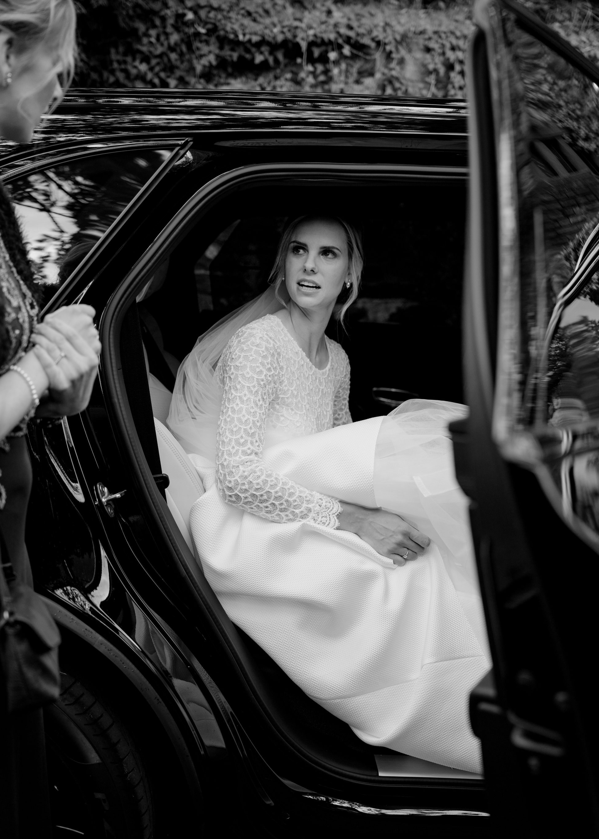 Bride stepping out of black Bentley luxury car in lace wedding dress, Villa Rothschild Frankfurt