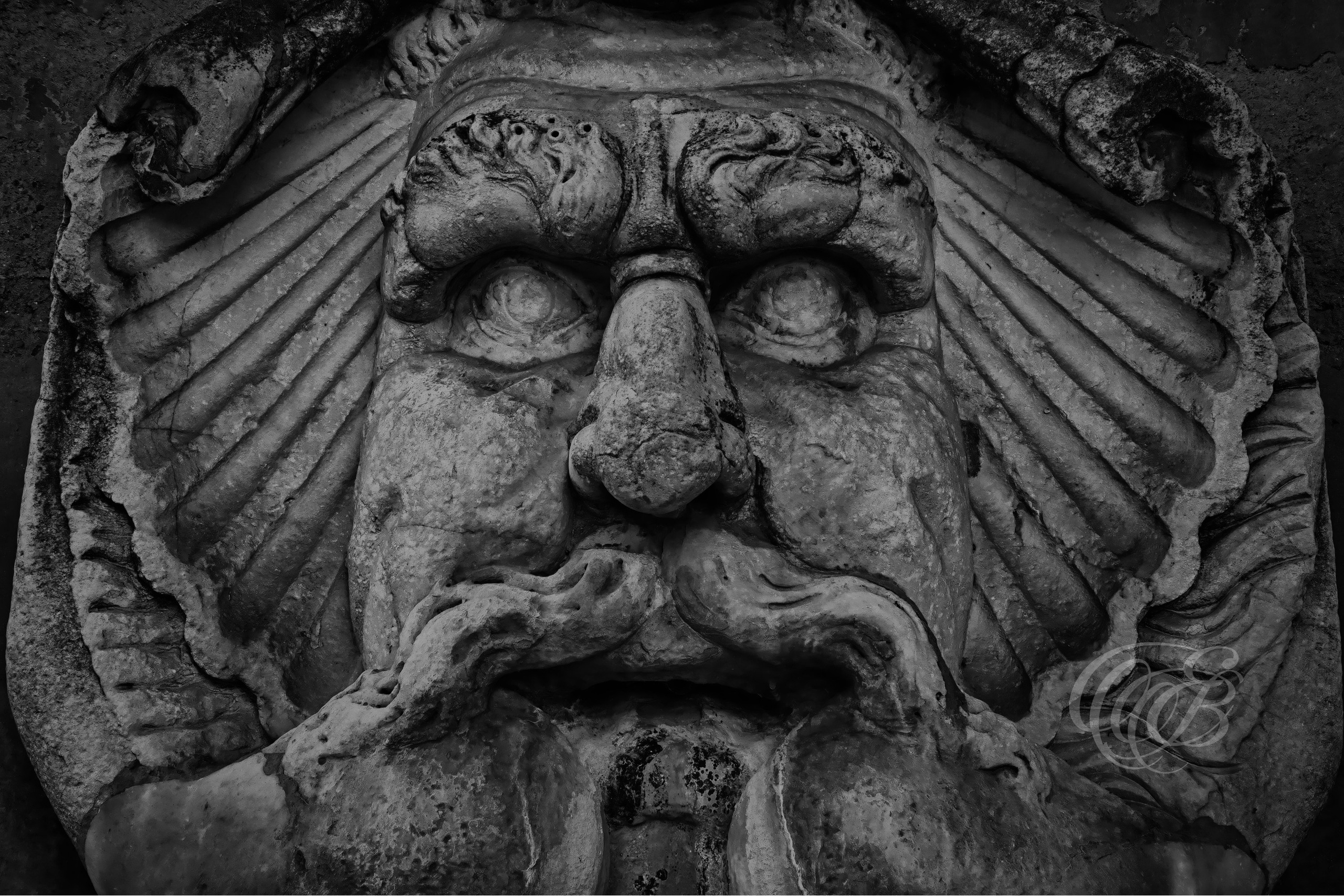 Rome Italy - Roman mask from the entrance to the Orange Garden - B&W - Eduardo Bartoli Fine Art Photography - Black and white photograph of a Roman mask from the entrance to the Orange Garden in Rome, Italy – fine art photography by Eduardo Bartoli.
