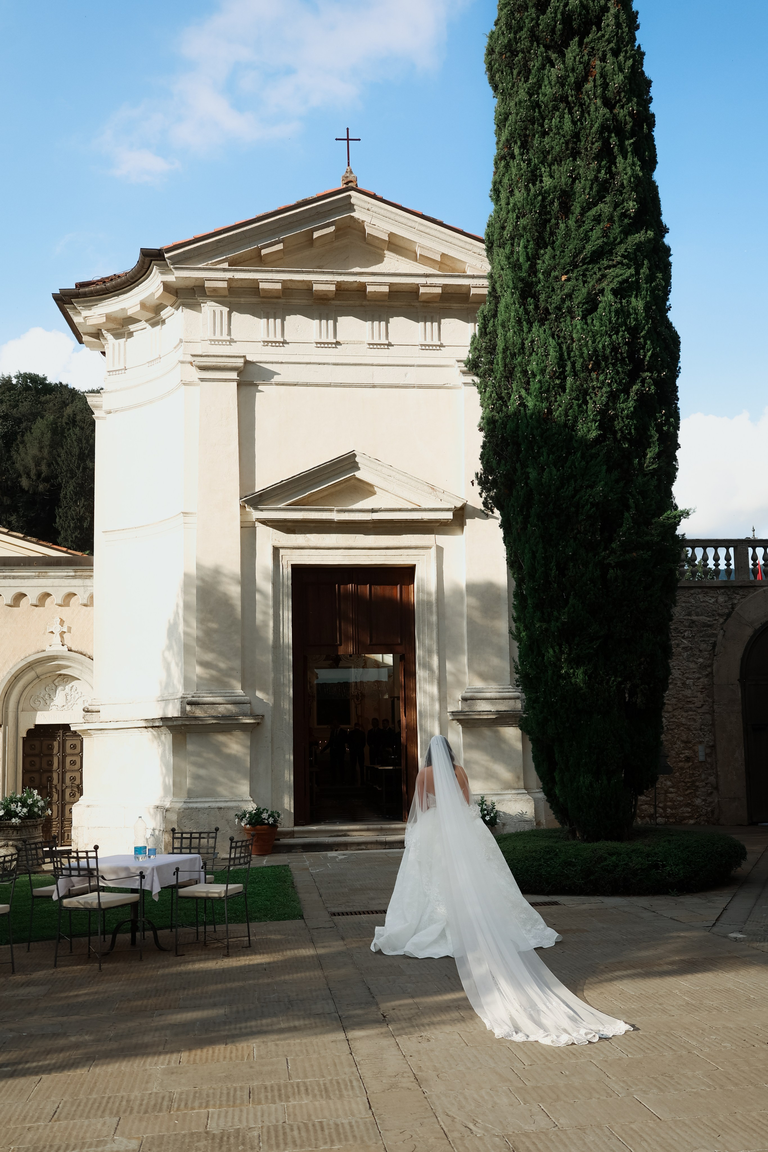 Bride walking down the aisle in a softly lit church.
