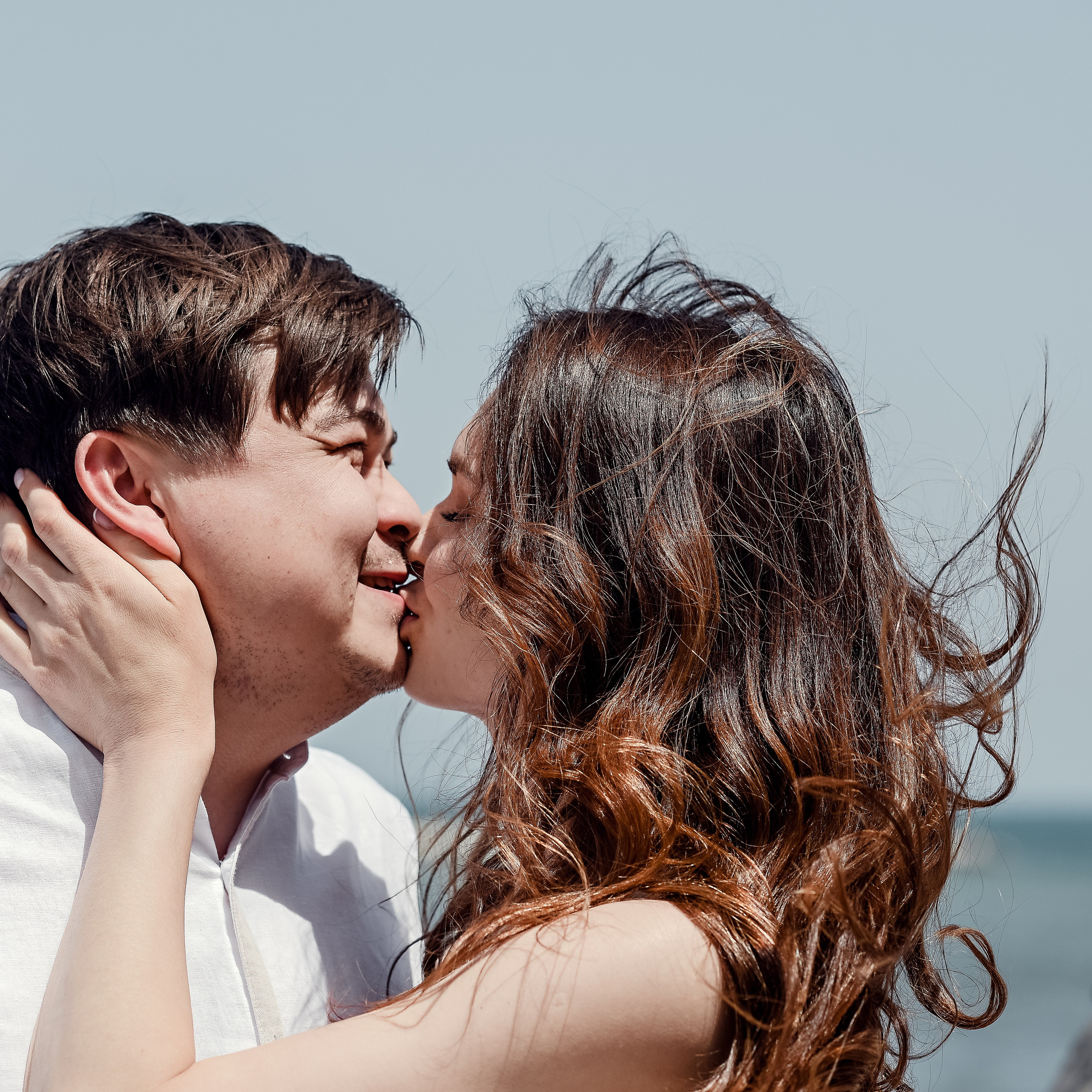 A couple in love kissing in front of the sea in Bari