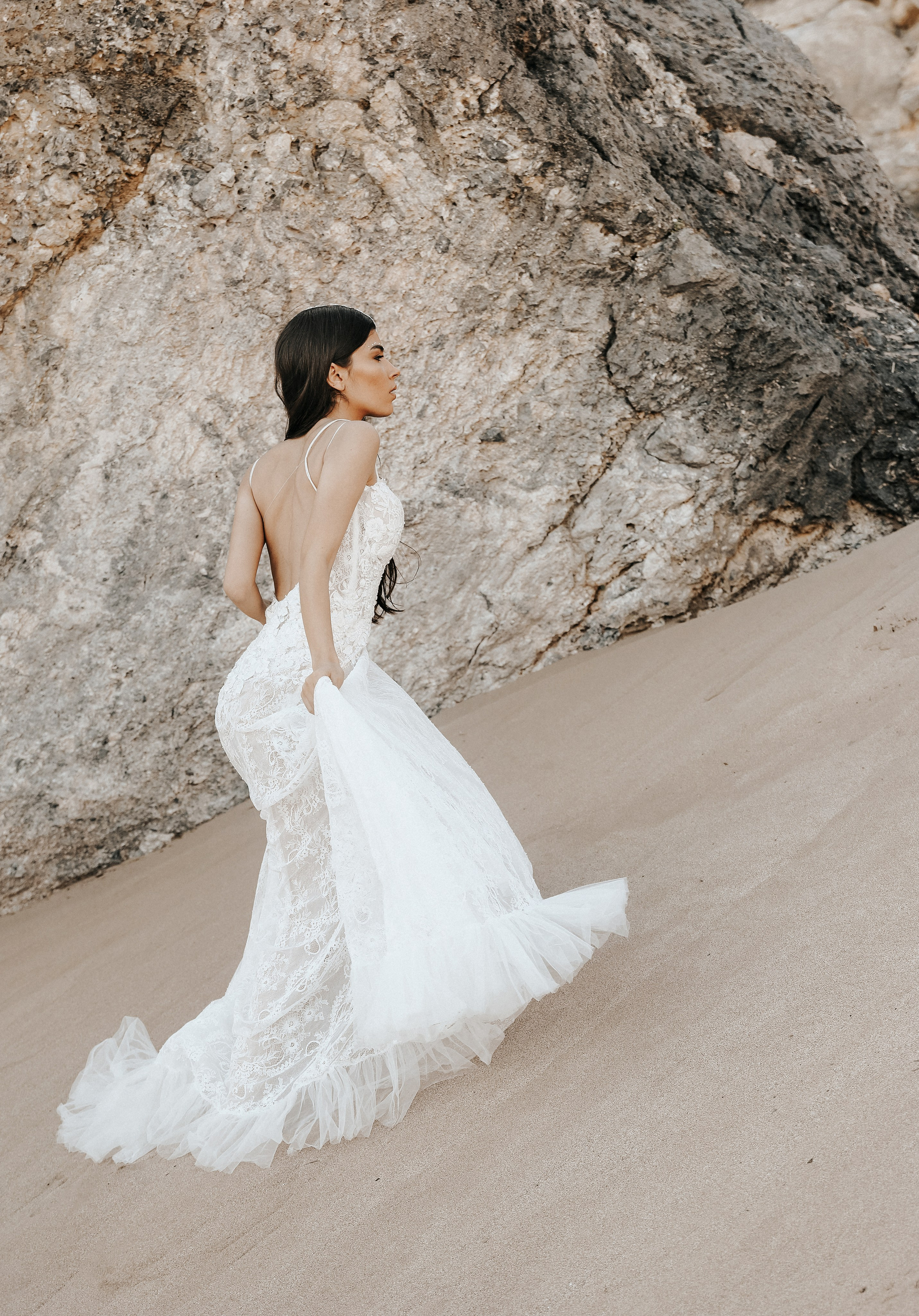 Art photoshoot of a girl in a wedding dress in the desert on a beach Tsampika in Rhodes