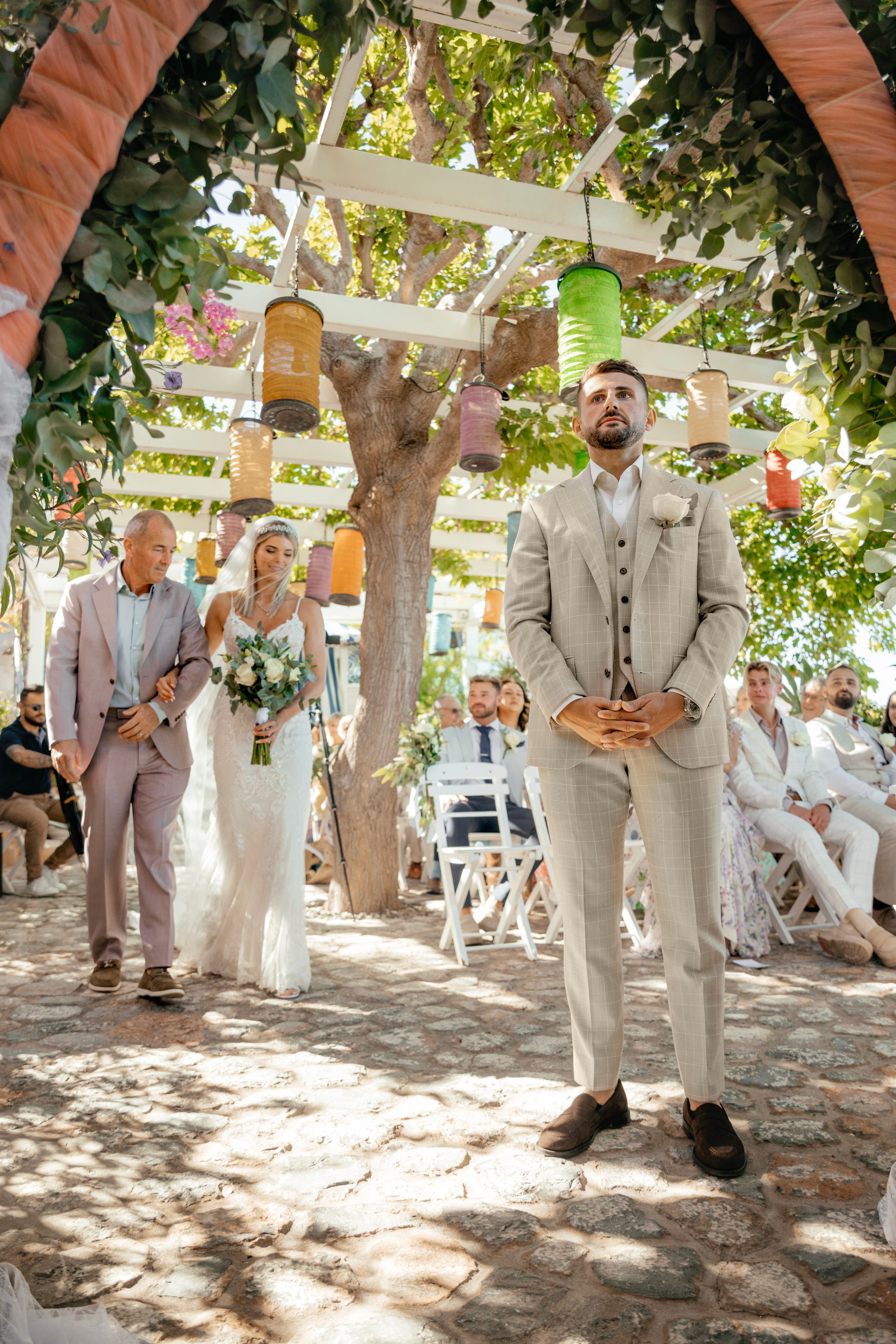 Bride walking down with her father in a flowing white gown. Wedding photographer, Rhodes