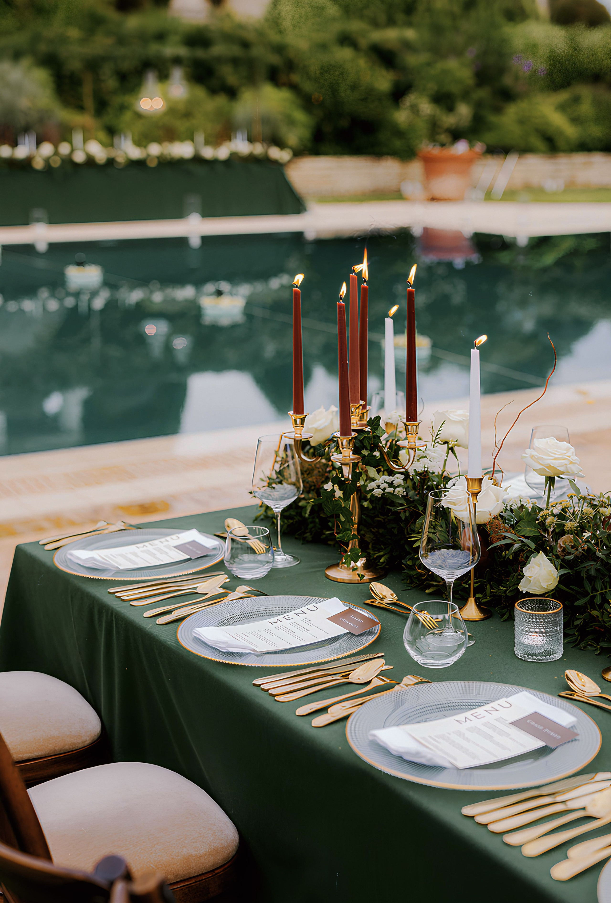 Elegant birthday celebration with greenery, candles and stylish outdoor table décor.