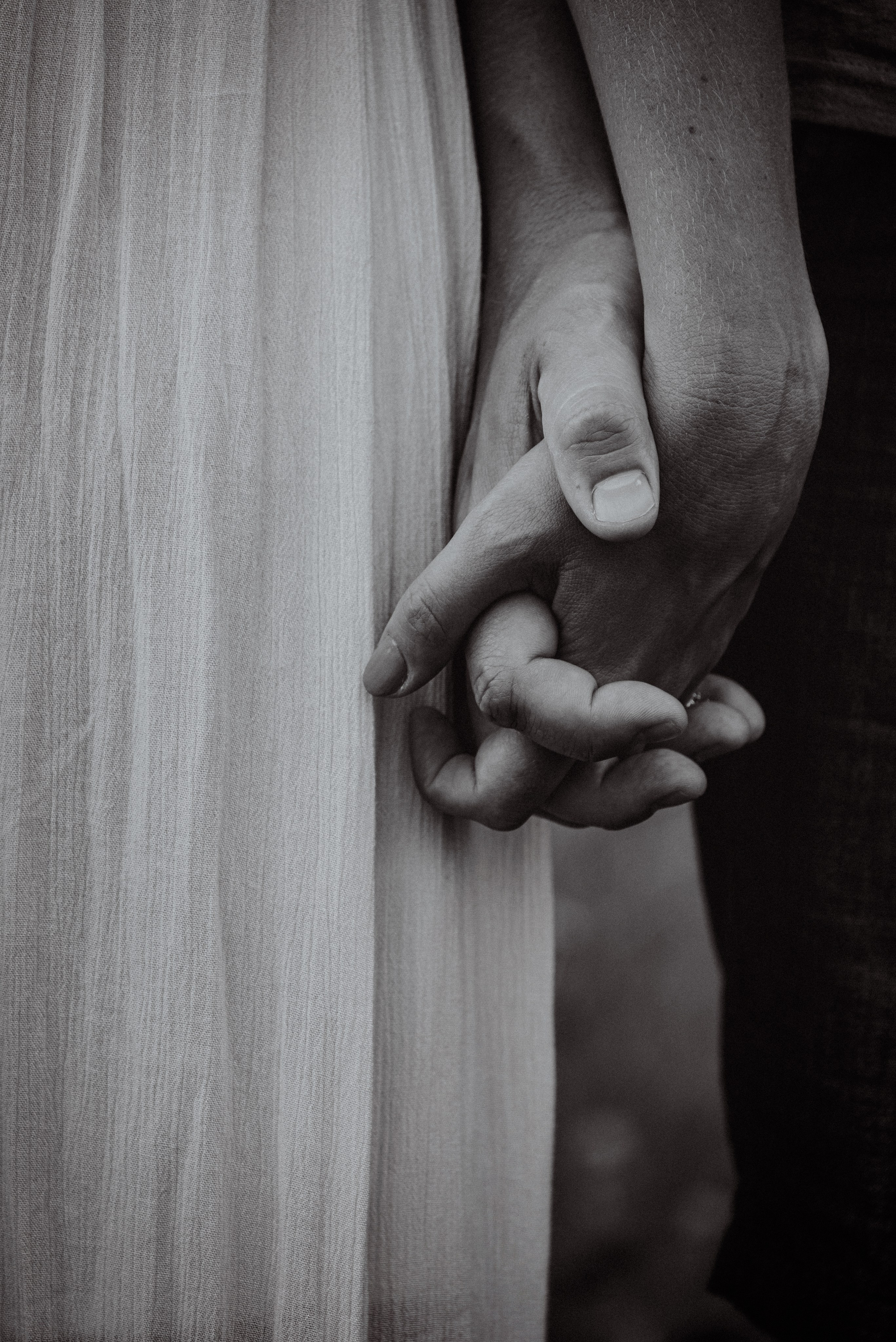 Candid moment of a couple strolling hand in hand through a scenic park in Fox Valley, captured in natural light.