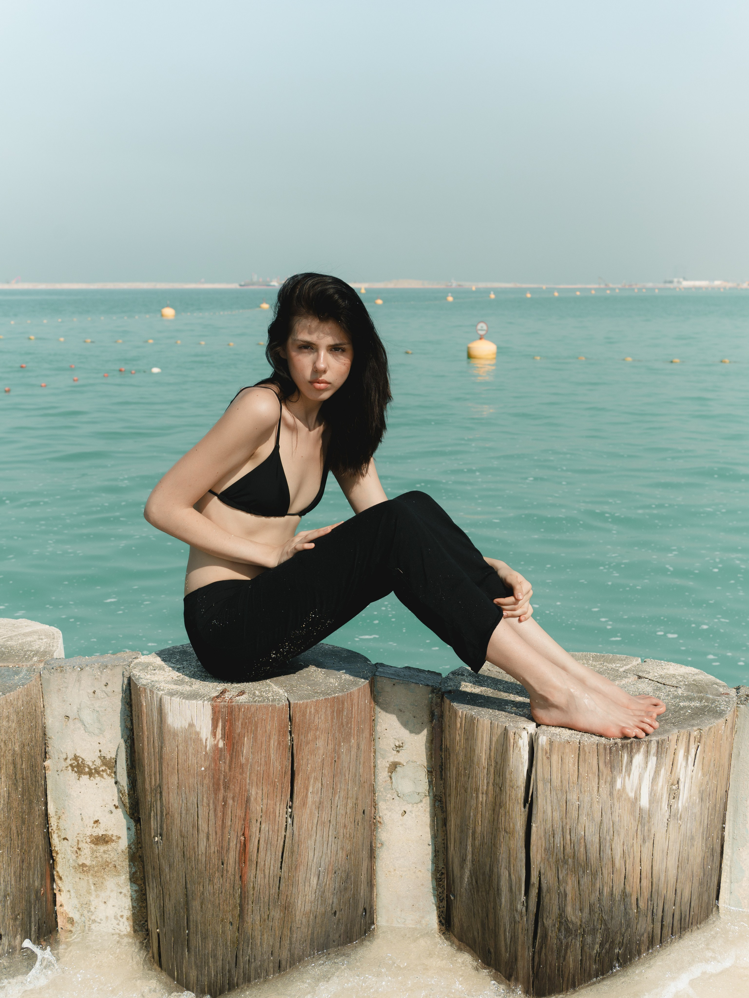 Fashion portrait series on the beach in minimalistic swimwear look. Alisha Geva | Contemporary fashion women’s portrait Dubai