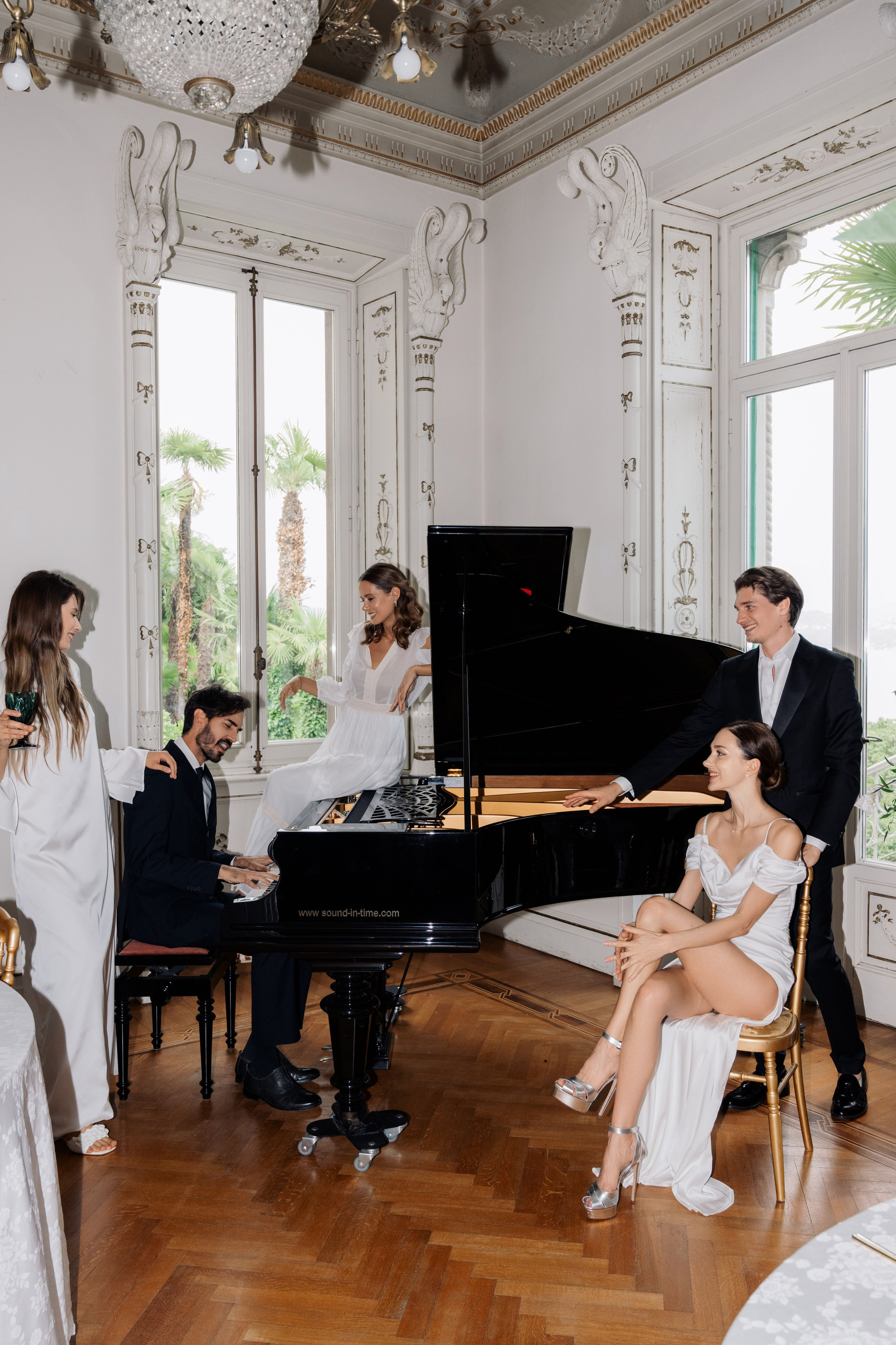 a man and woman playing a piano in a room