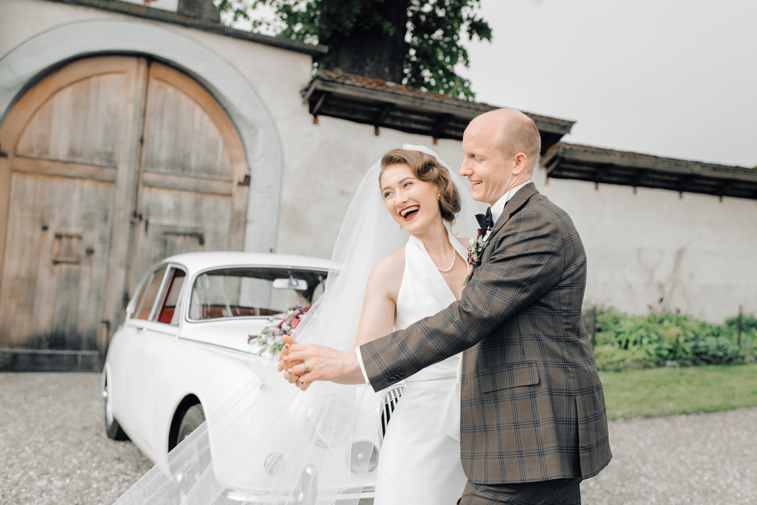 A wedding couple dancing and laughing