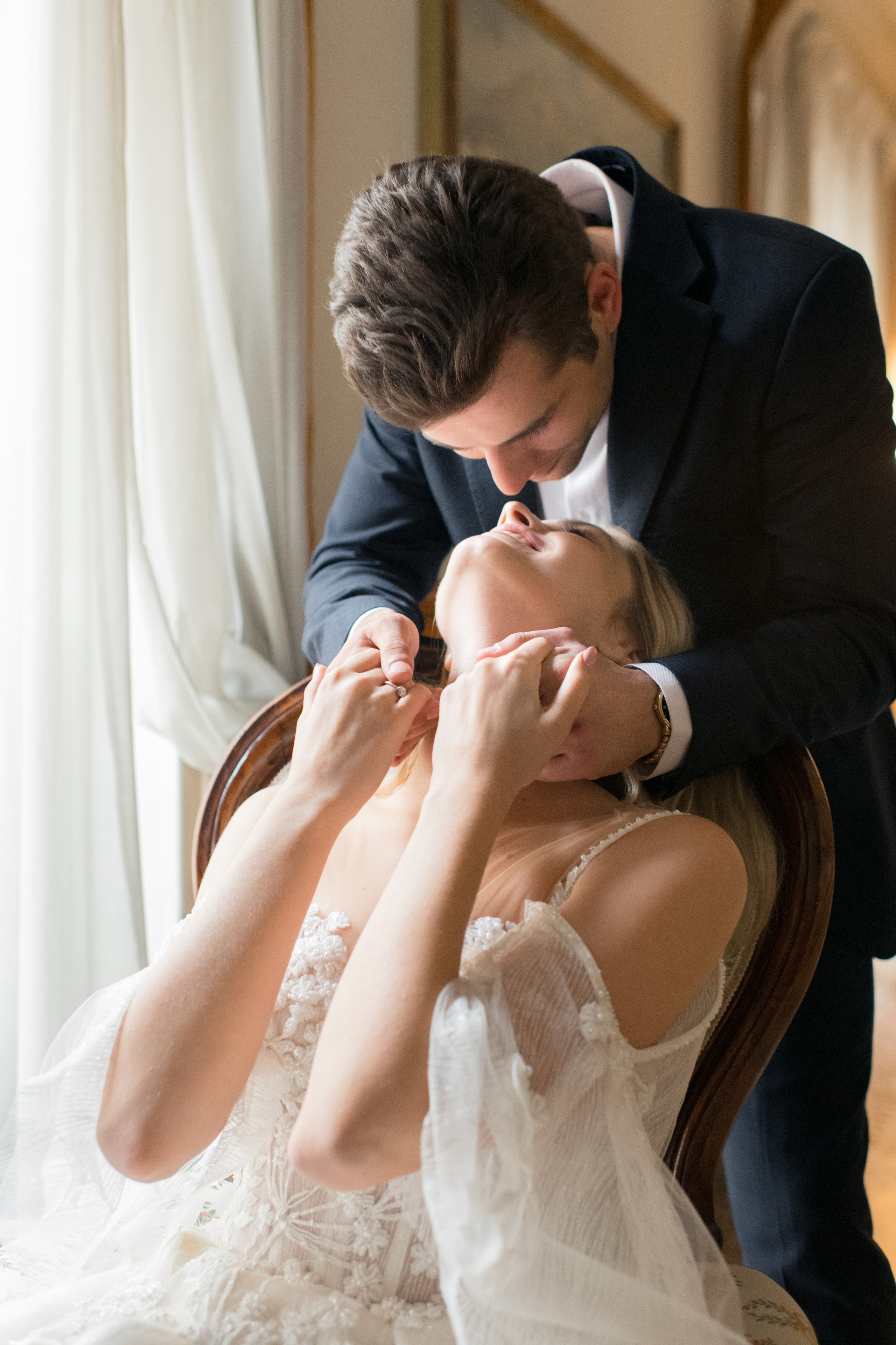 A romantic wedding couple in Milan, Italy. A fiance is kissing his beautiful bride